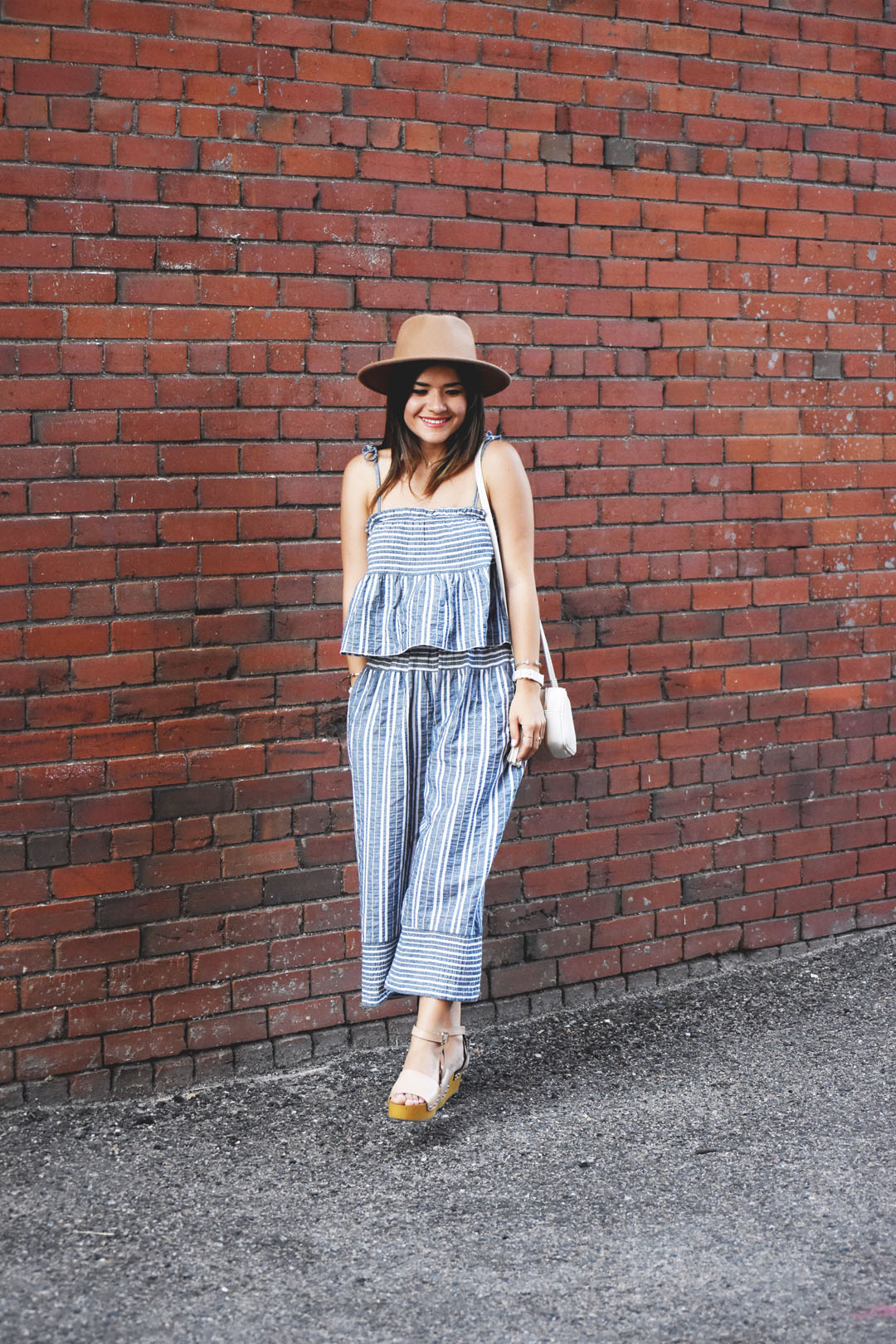 Carolina Hellal of Chic Talk wearing a summery look with a set of striped pants and top via Chicwish and Sam Edelman platforms.