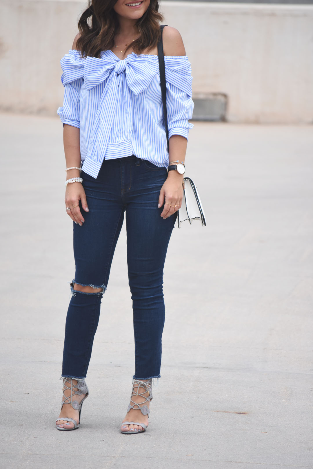 Carolina Hellal of the fashion blog Chic Talk wearing a casual look with a SheIn off the shoulder top and Madewell ripped jeans