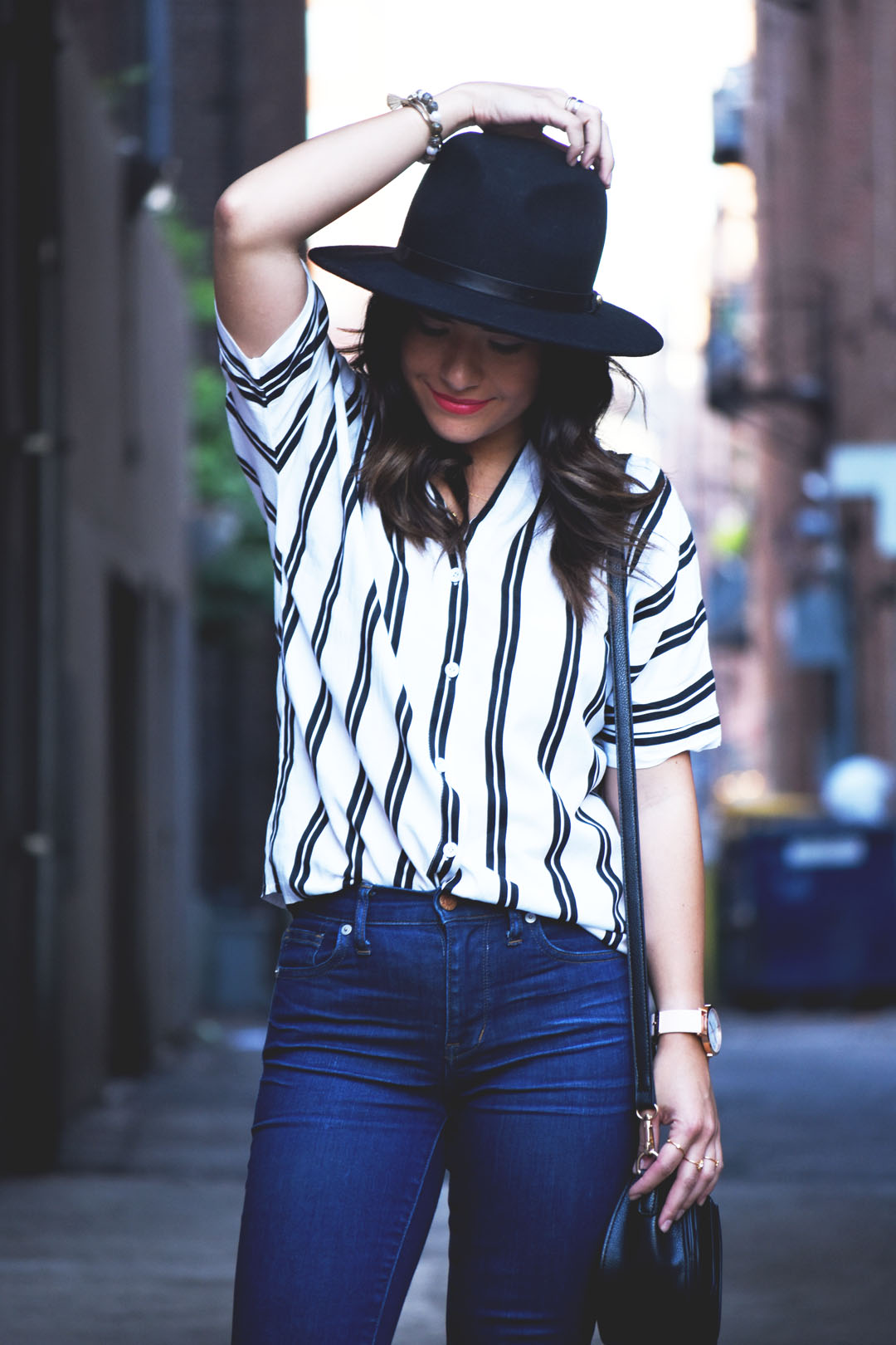 Carolina Hellal of Chic Talk wearing a Romwe stripe top, Madewell skinny dark wash jeans and Forerver21 black wool hat