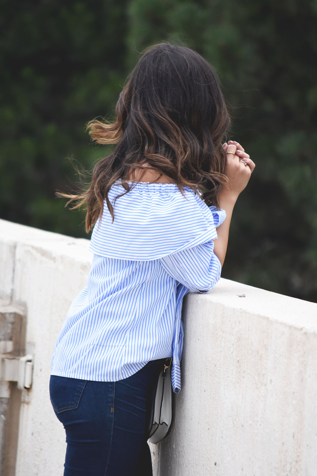 Carolina Hella of Chic Talk wearing an SheInside off the shoulder blue striped top and Madewell jeans