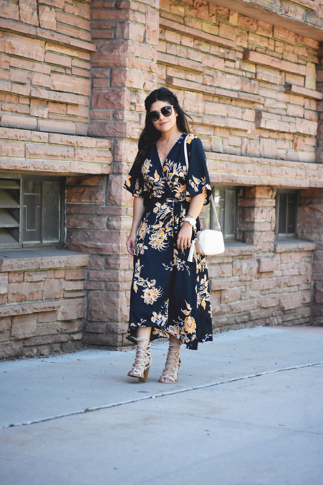 Carolina Hellal of Chic Talk wearing a floral maxi dress, Lasula lace up beige sandals, and an h&m beige crossbody bag. 