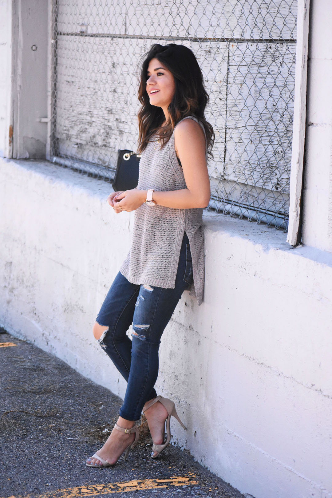 Carolina Hellal of Chic Talk wearing American Eagle high rise jeans, Christian Paul rose gold marble watch, and an ASTR knit top. 
