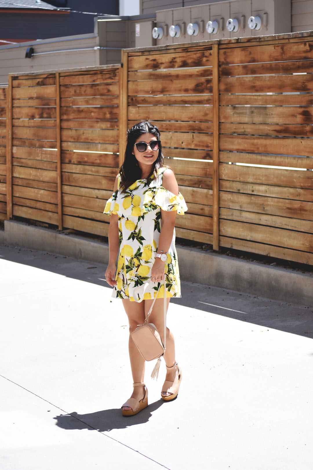 Carolina Hellal of Chic Talk wearing a lemon printed yellow summer dress via Romwe, H&M crossbody bag, and Sam Edelman beige platform sandals