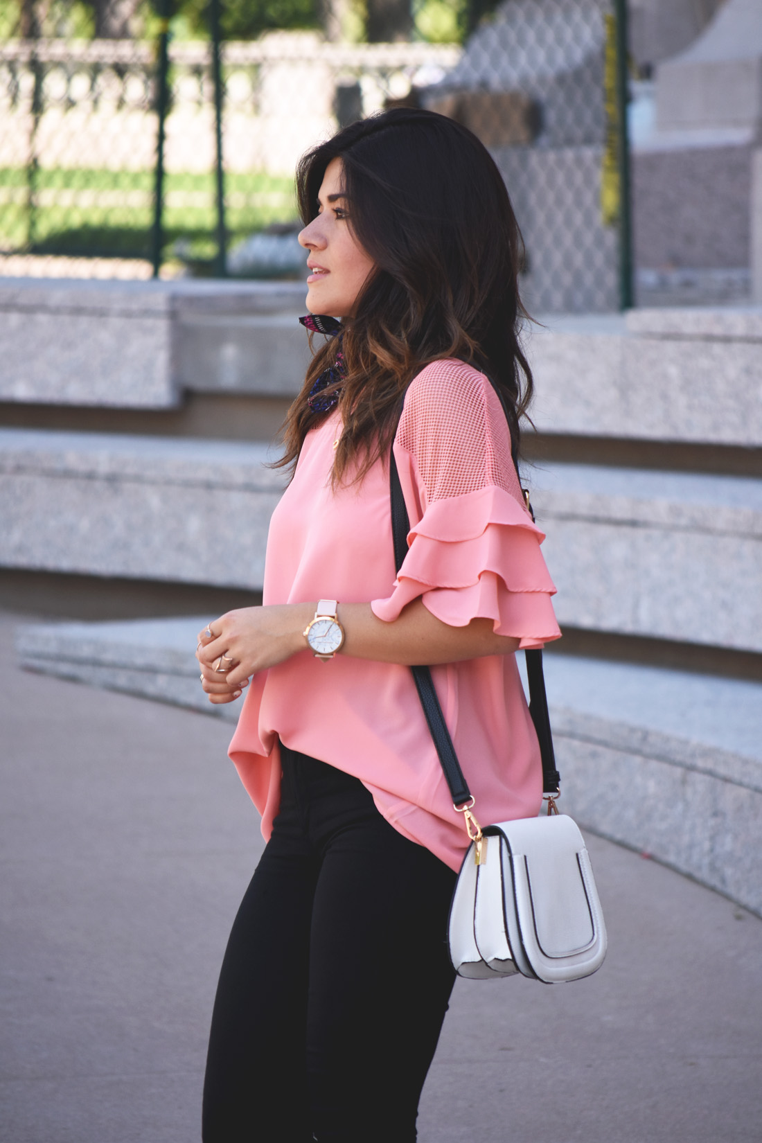 Carolina Hellal of Chic Talk wearing a VIPme pink top, Christian Paul watch, and solesociety bag. 