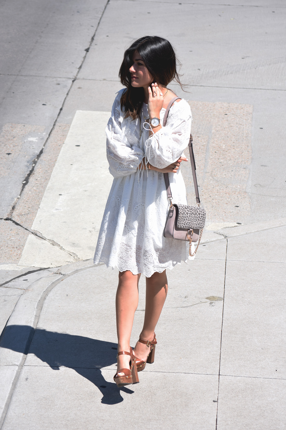 Carolina Hellal of Chic Talk wearing a white summer dress via VIPME, Kendra Scott accessories, and Macy's wooden platform sandals. 