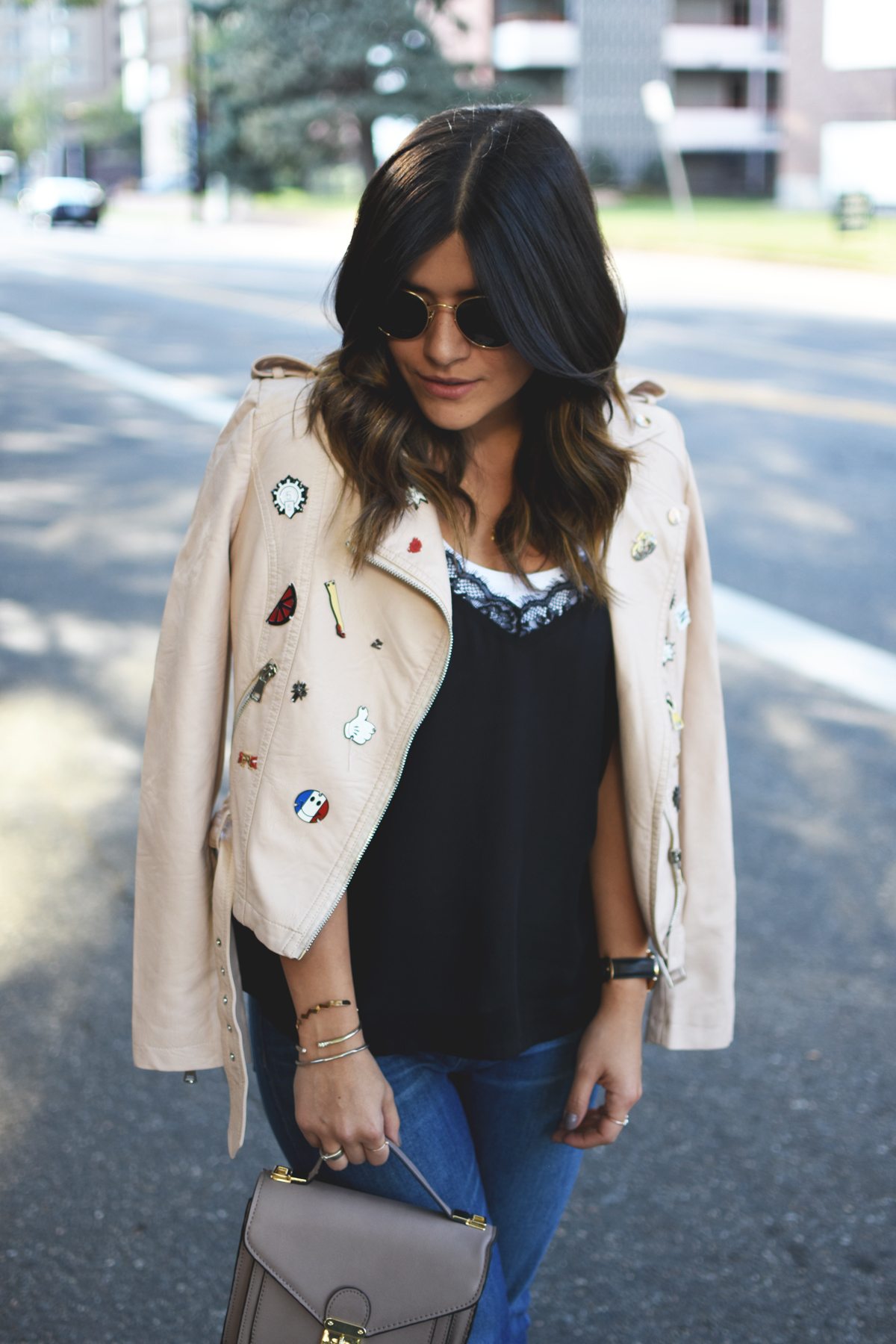 Carolina Hellal of Chic Talk wearing a Dezzal blush faux leather jacket, Forever 21 lace black camisol, Madewell jeans, Rayban rounded sunglasses, and Topshop blush lace up sandals.