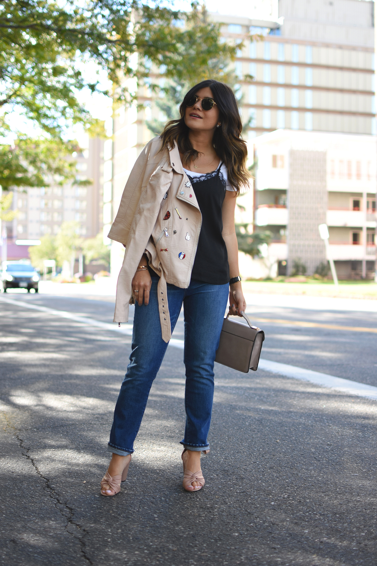 Carolina Hellal of Chic Talk wearing a Dezzal blush faux leather jacket, Forever 21 lace black camisol, Madewell jeans, Rayban rounded sunglasses, and Topshop blush lace up sandals.