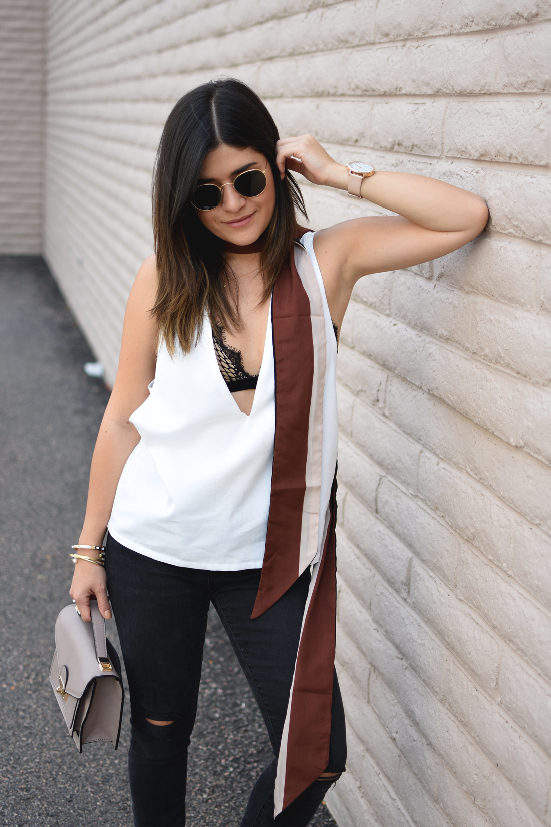 Carolina Hellal of the fashion blog Chic Talk wearing a Tobi white top, Forever21 lace bralette and Madewell skinny ripped jeans