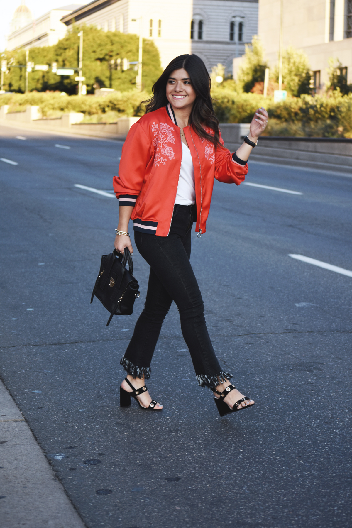 Carolina Hellal of Chic Talk wearing an H&M red bomber jacket, Dezzal fringe jeans, and Public Desire sandals
