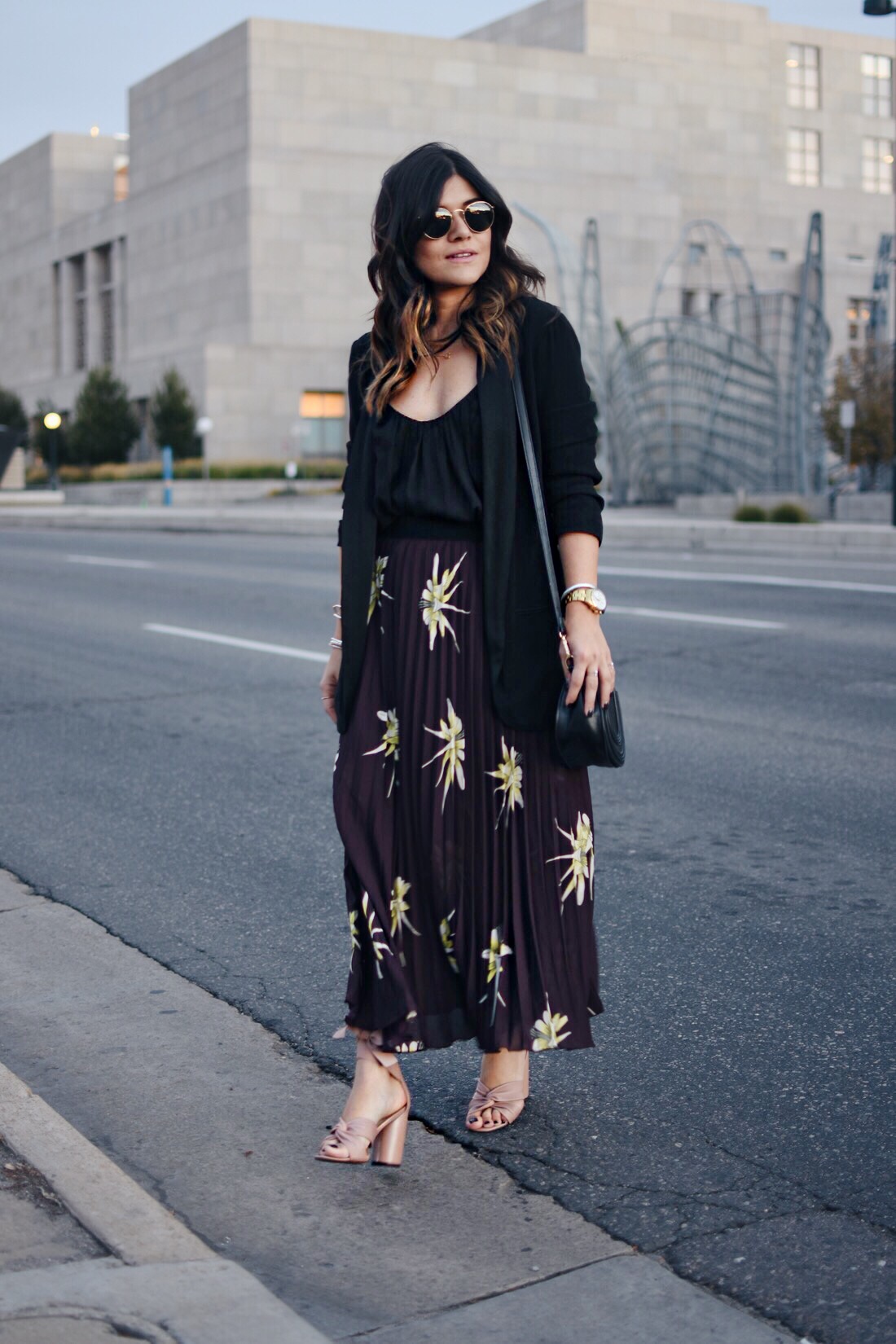 Carolina Hellal of Chic Talk wearing an H&M pleated burgundy skirt, Black blazer , Rayban rounded sunglasses and Topshop blush sandals