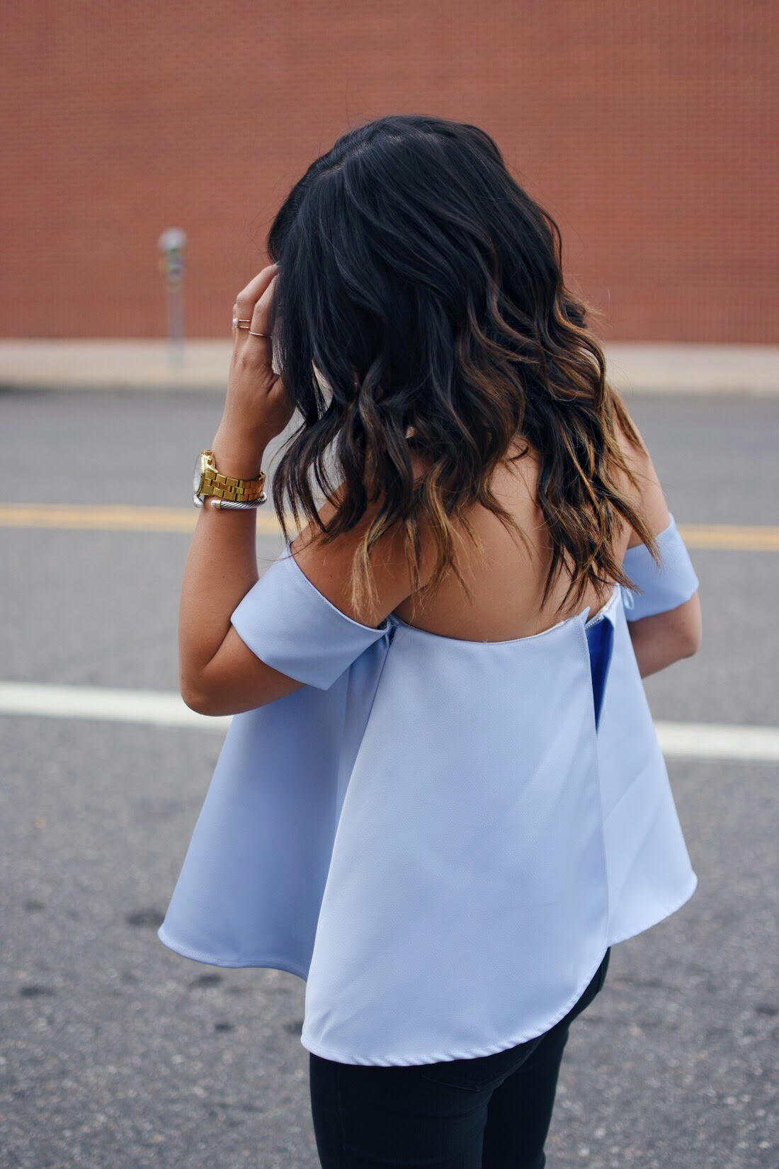 Carolina Hellal of Chic Talk wearing a Chicwish a strapless top, Madewell jeans, and Gold timex watch