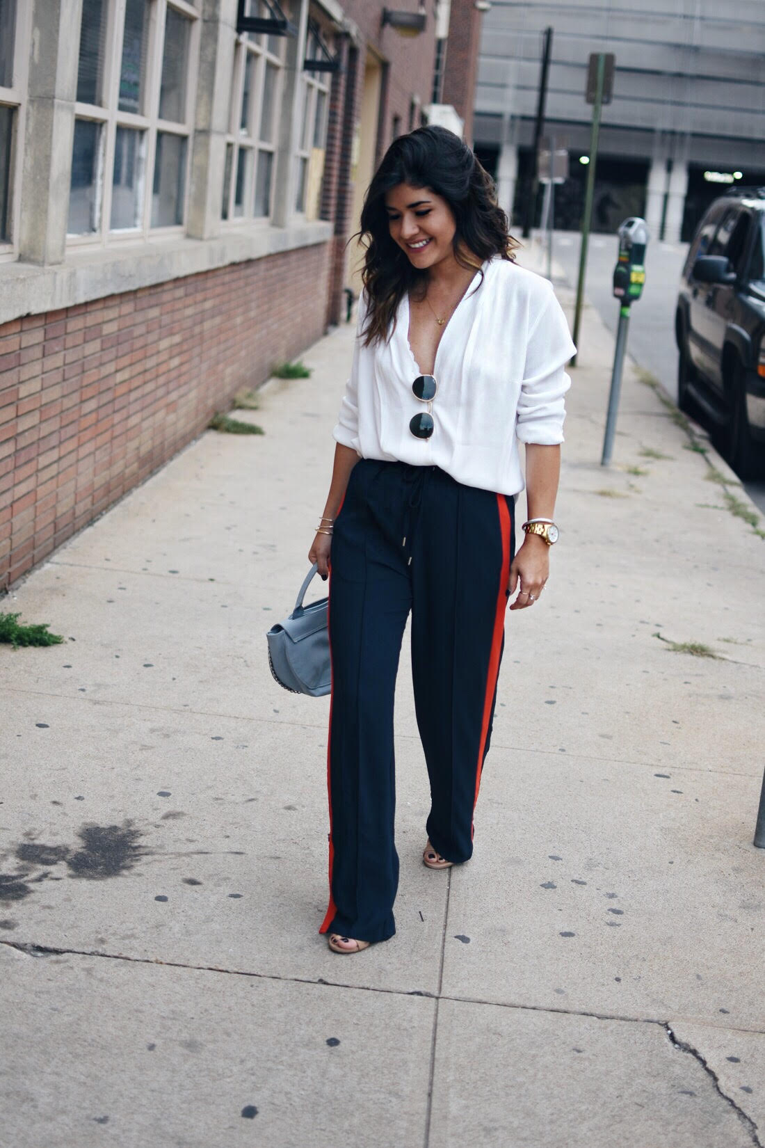 Carolina Hellal of Chic Talk wearing H&M navy blue track pants, white cross front blouse and Rayban Rounded 50mm sunglasses