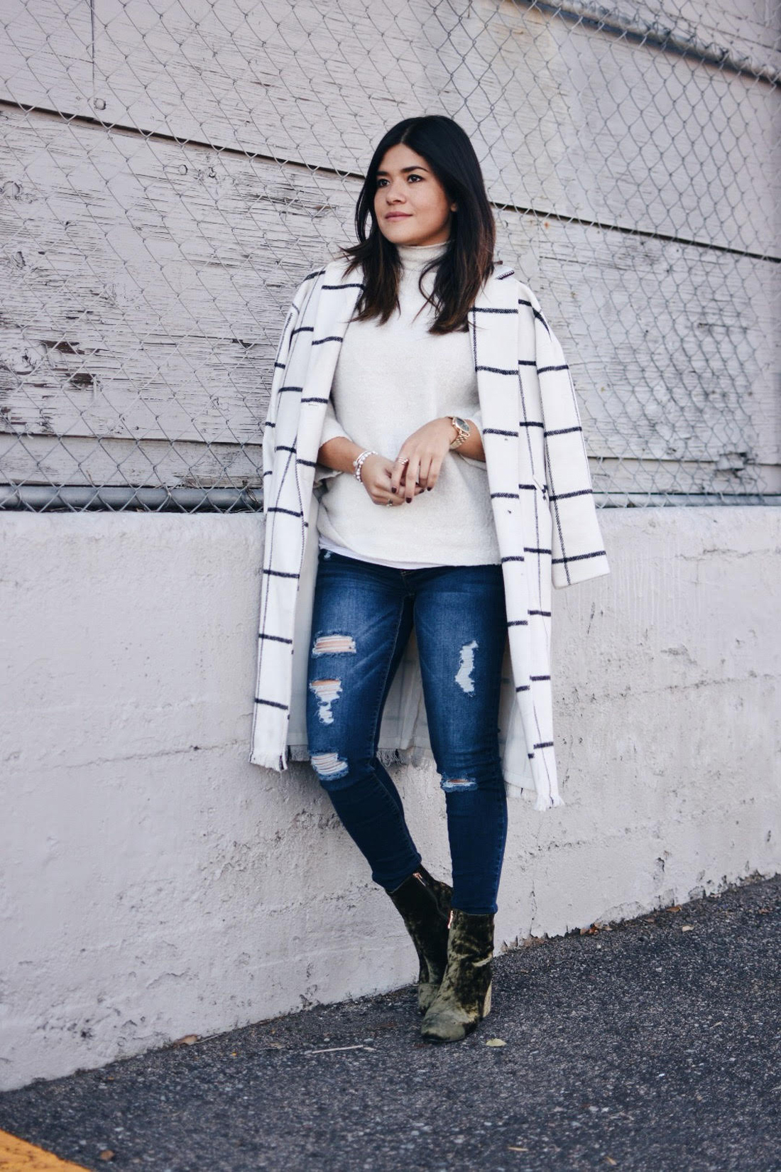 Carolina Hellal of Chic Talk wearing a Chicwish plaid coat, American Eagle jeans, EGO green velvet booties and a Forever21 beige sweater