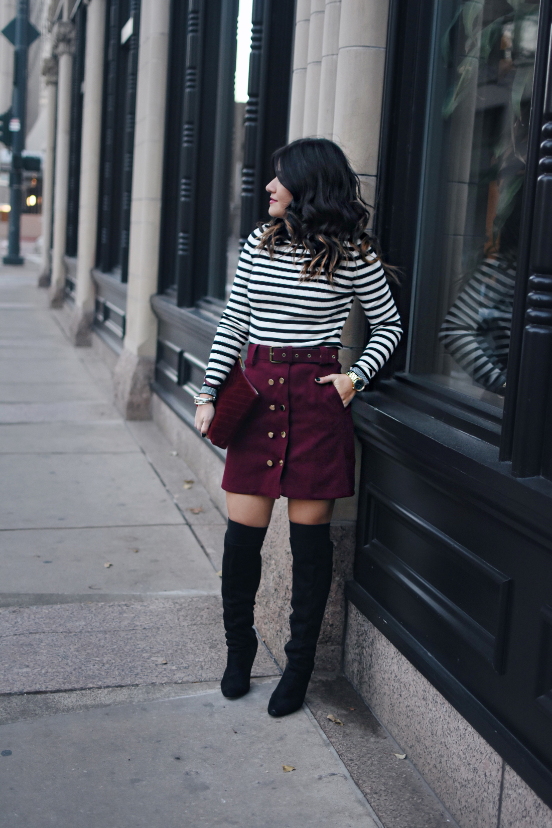 Carolina Hellal of Chic Talk wearing a burgundy mini skirt, gap stripped sweater and black over the knee boots