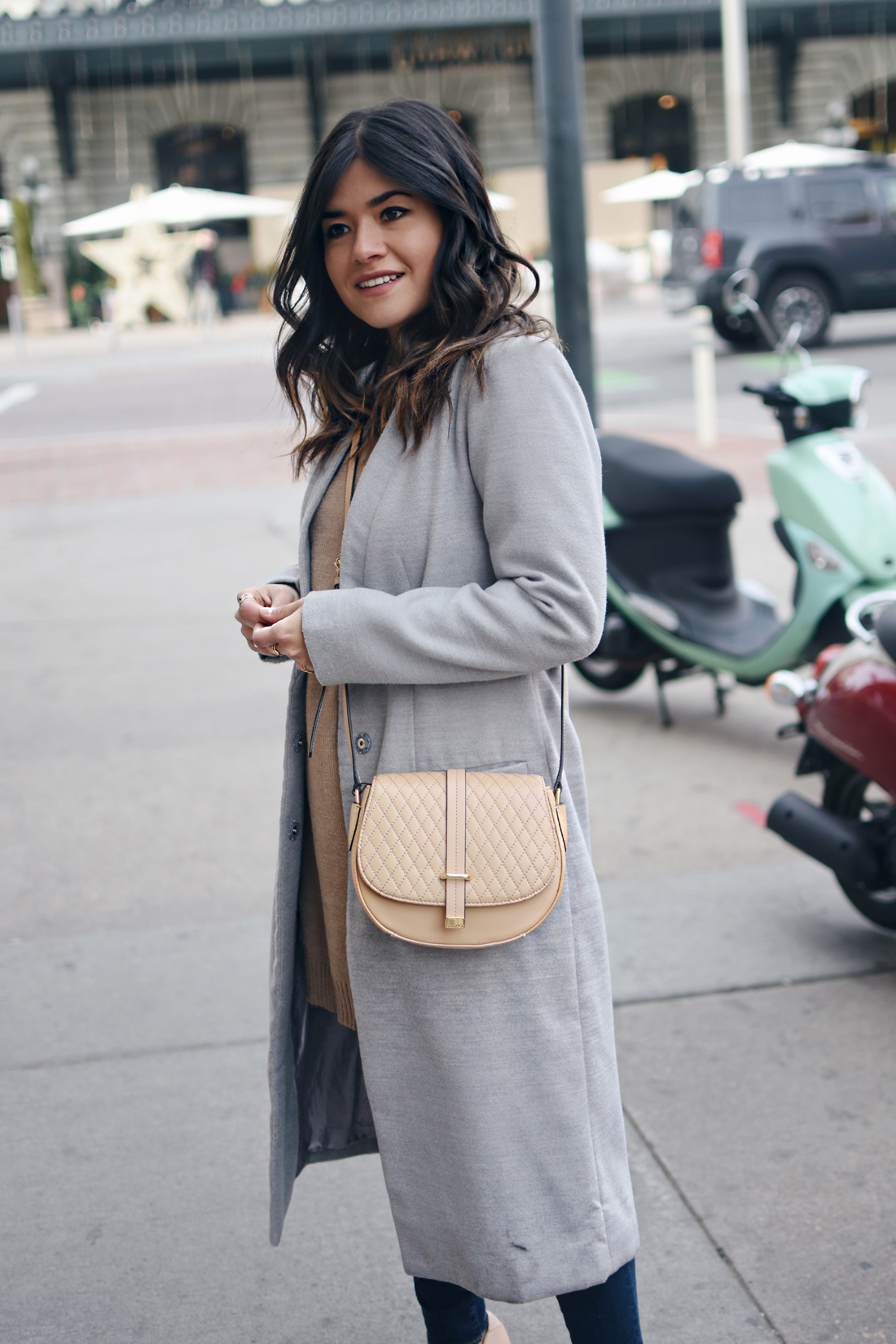 Carolina Hellal of Chic Talk wearing a Shein gray long coat, Paige skinny jeans, Calvin Klein bag, NA-KD sweater, and Sam Edelman Shoes.