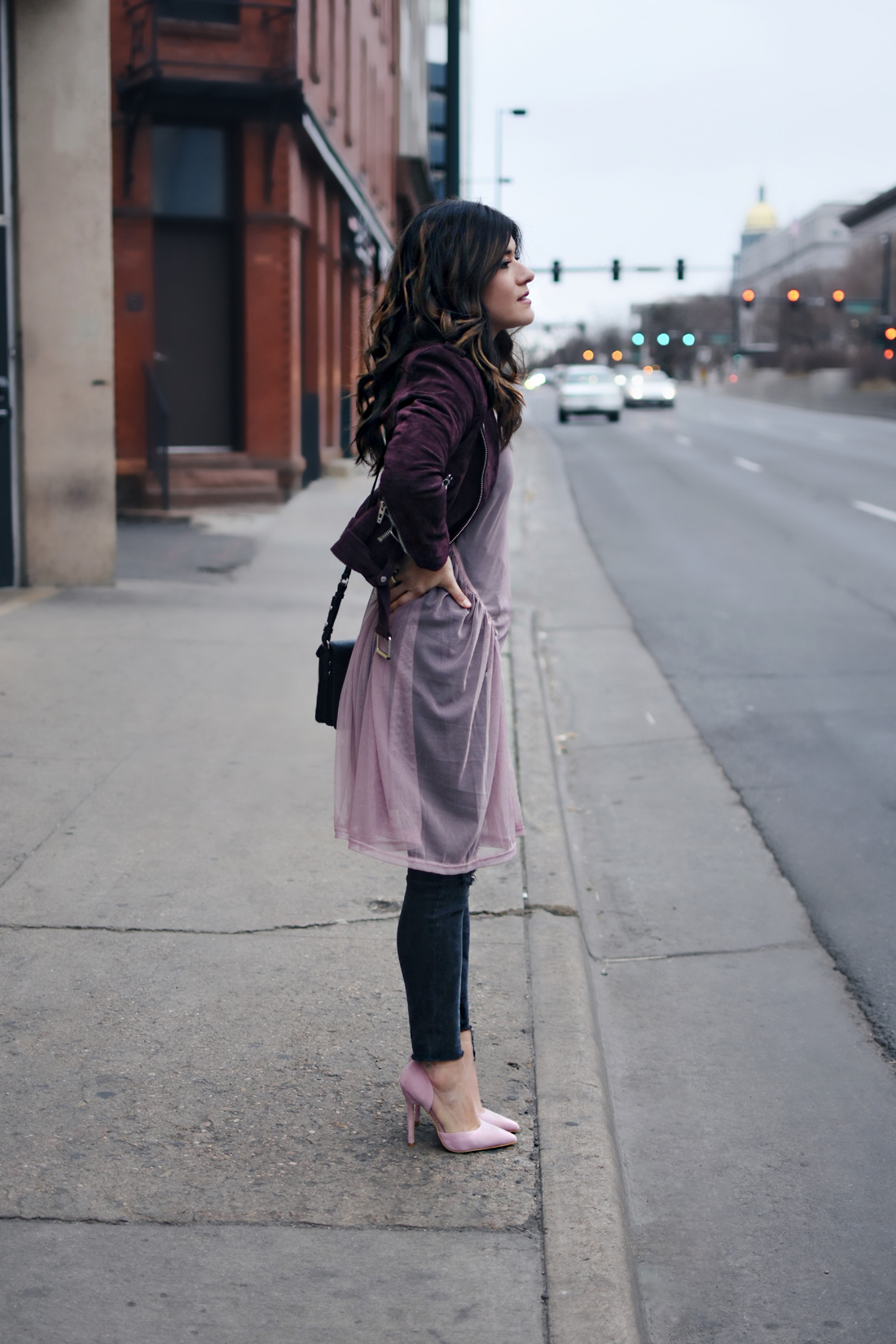 Carolina Hellal of Chic Talk wearing a Nordtrom suede burgundy jacket, madewell jeans, River Island tulle top in lilac, Rebecca Minkoff bag, and public Desire shoes
