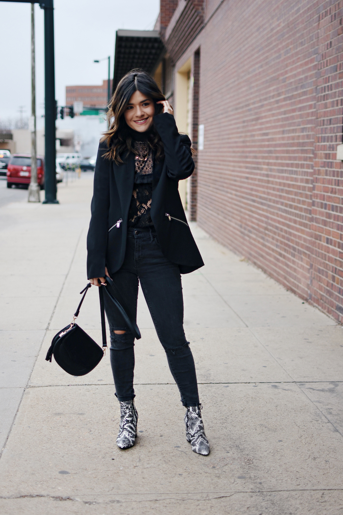 Carolina Hellal of Chic Talk wearing an Asos black lace top, Madewell jeans, Public Desire snake print boots, BCBG blazer 