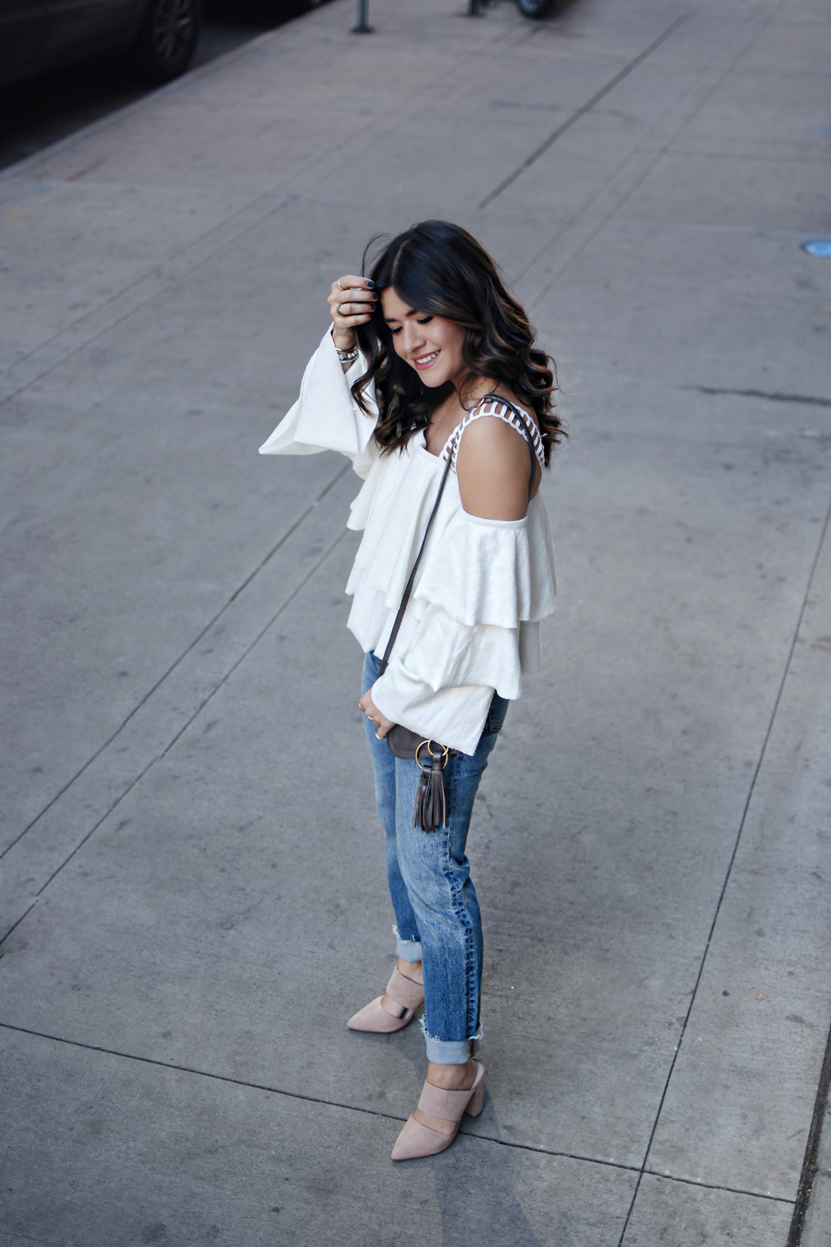 Carolina Hellal wearing a Moon River ruffle top, H&M straight jeans, na-kd nude mules, and See by Chloé polly crossbody bag