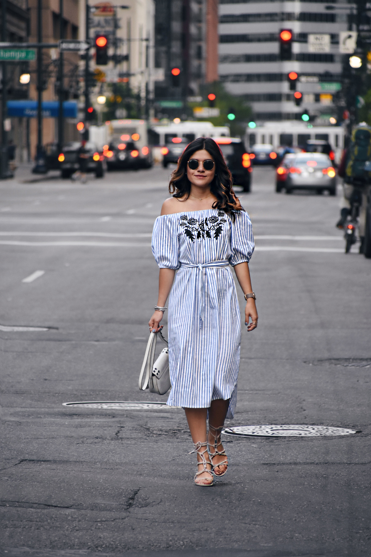 Carolina Hellal in downtown Denver wearing an off the shoulder shein dress, rayban sunglasses, marc jacobs watch and rebrecca minkoff shoes