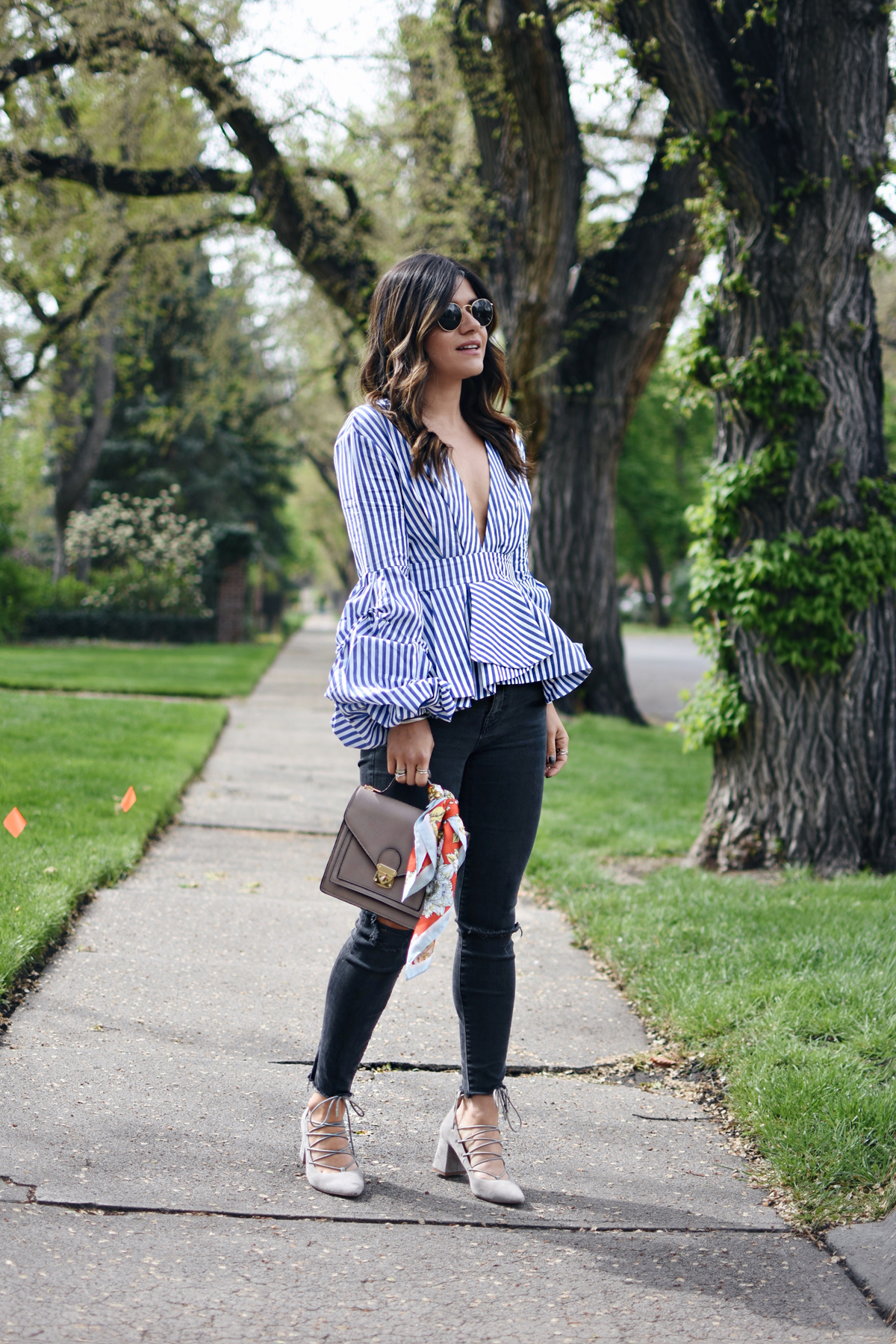 Carolina Hellal wearing a Shein stripe top, Madewell jeans, chinese laundry lace up shoes and rayban sunglasses