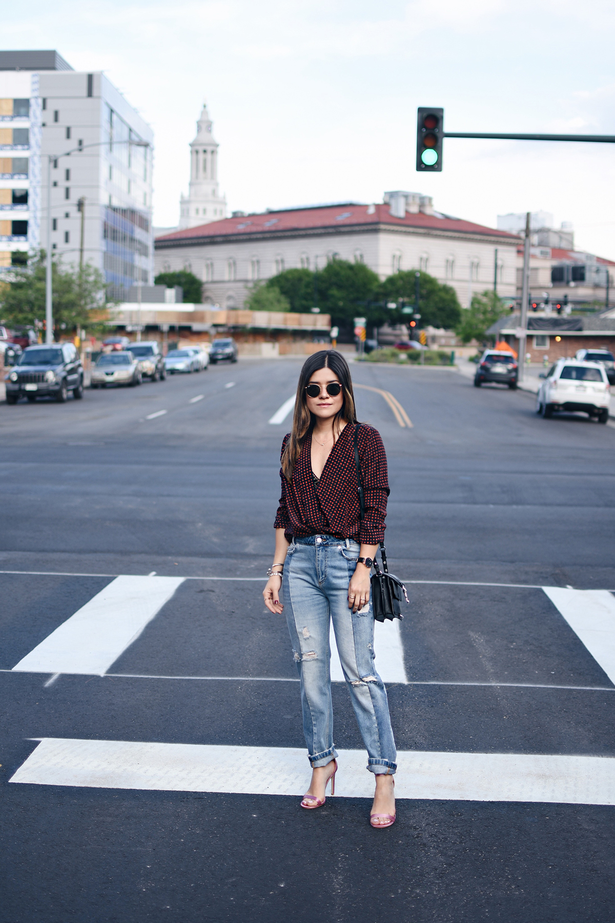 Carolina Hellal of Chic Talk wearing a DVF cross front top, Free People jeans, Rebecca Minkoff bag and Public Desire sandals. 
