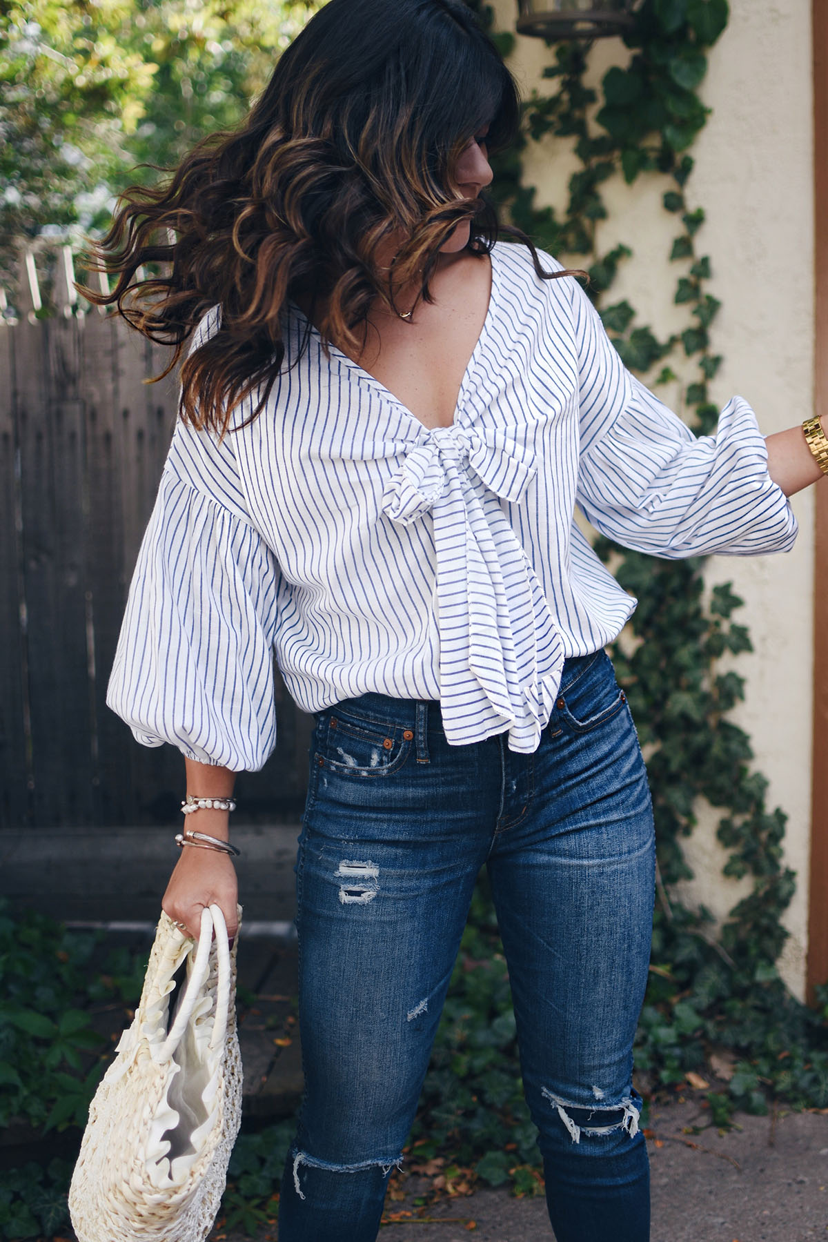 Carolina Hellal of Chic Talk wearing a Shein striped top, Madewell jeans, public Desire sandals and Shein beach bag