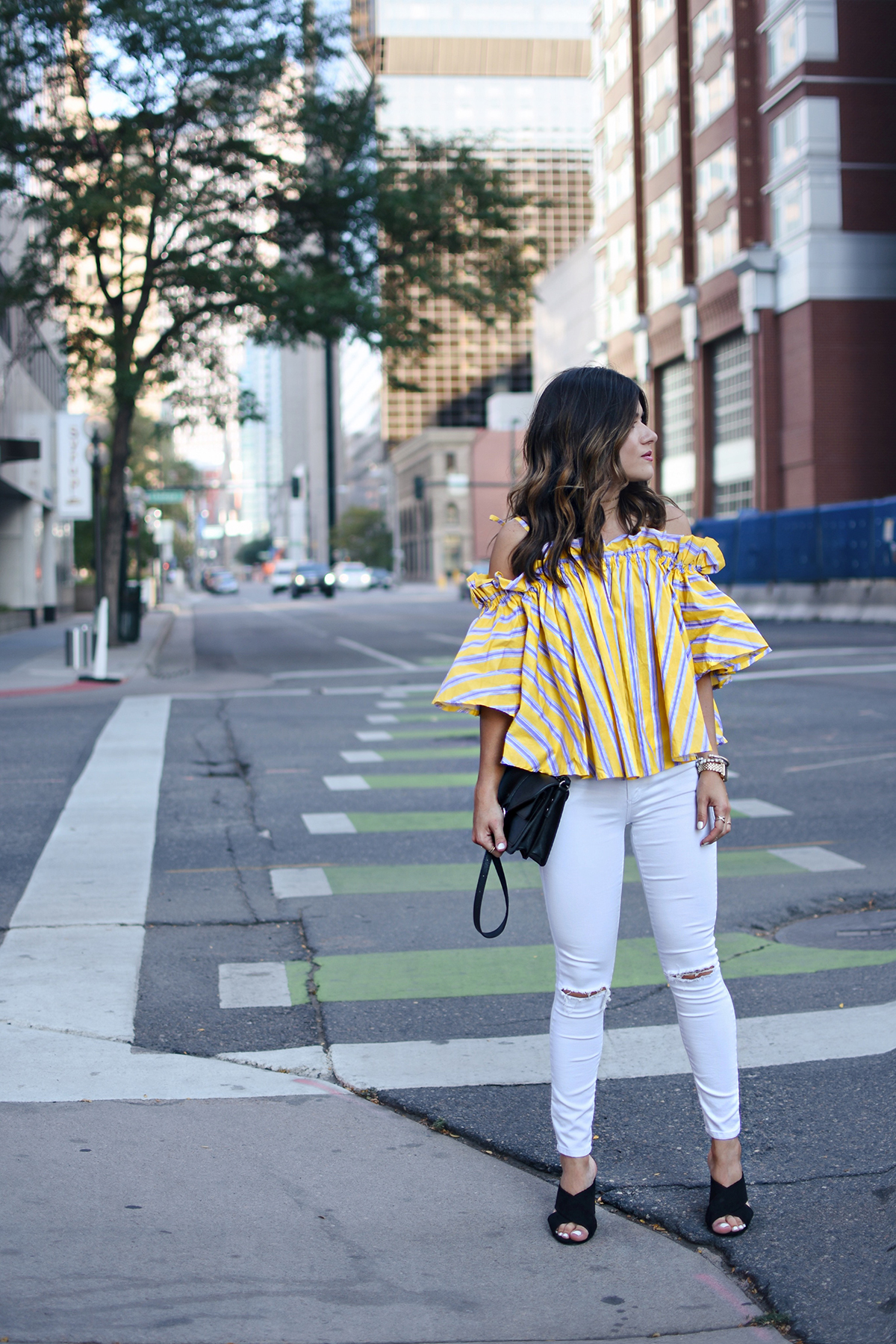 Carolina Hellal of Chic Talk wearing an off the shoulder yellow top via Chicwish, Topshop white jeans and Marc Fisher black slides