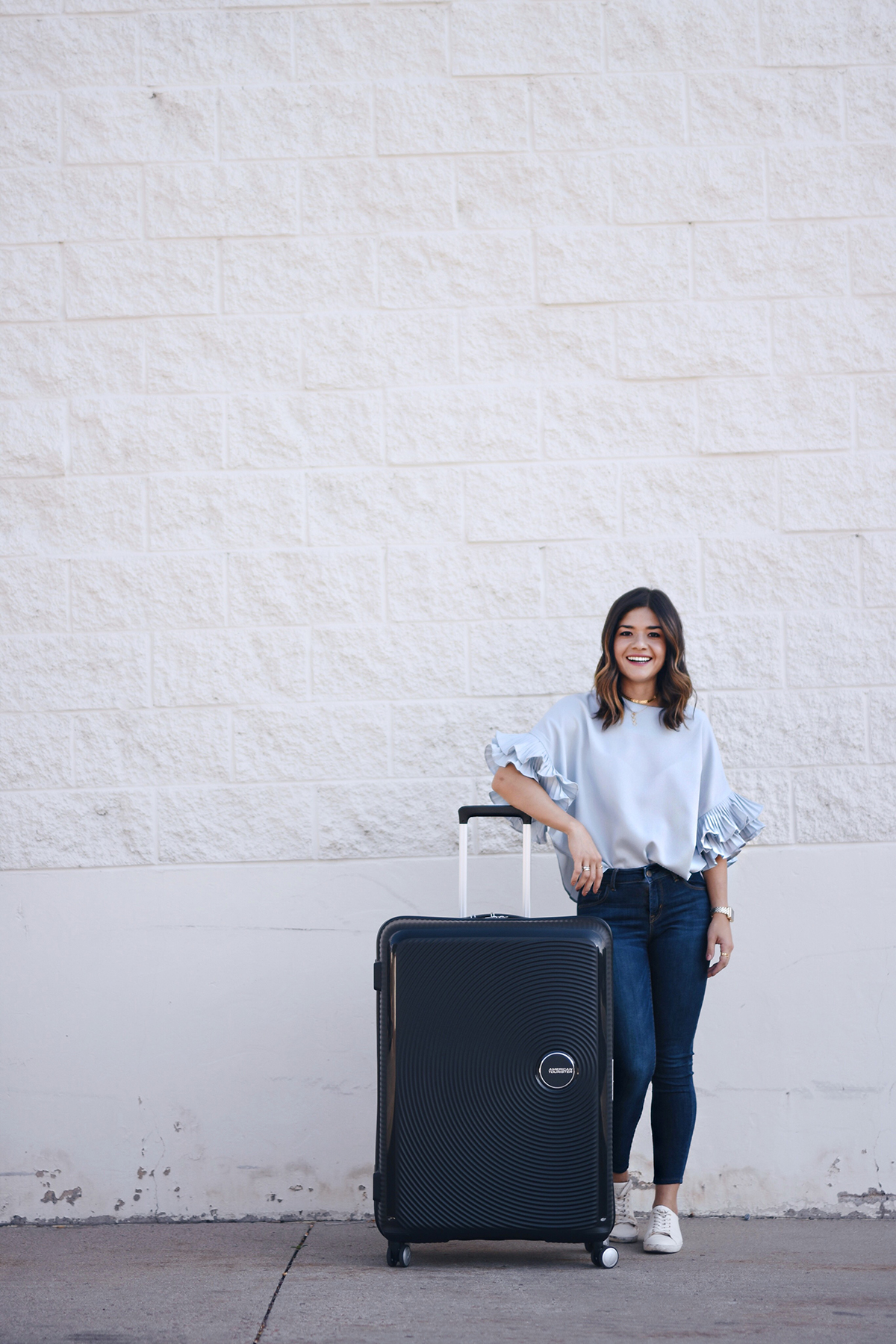 Carolina Hellal of Chic Talk with the American Tourister Curio bag in black.