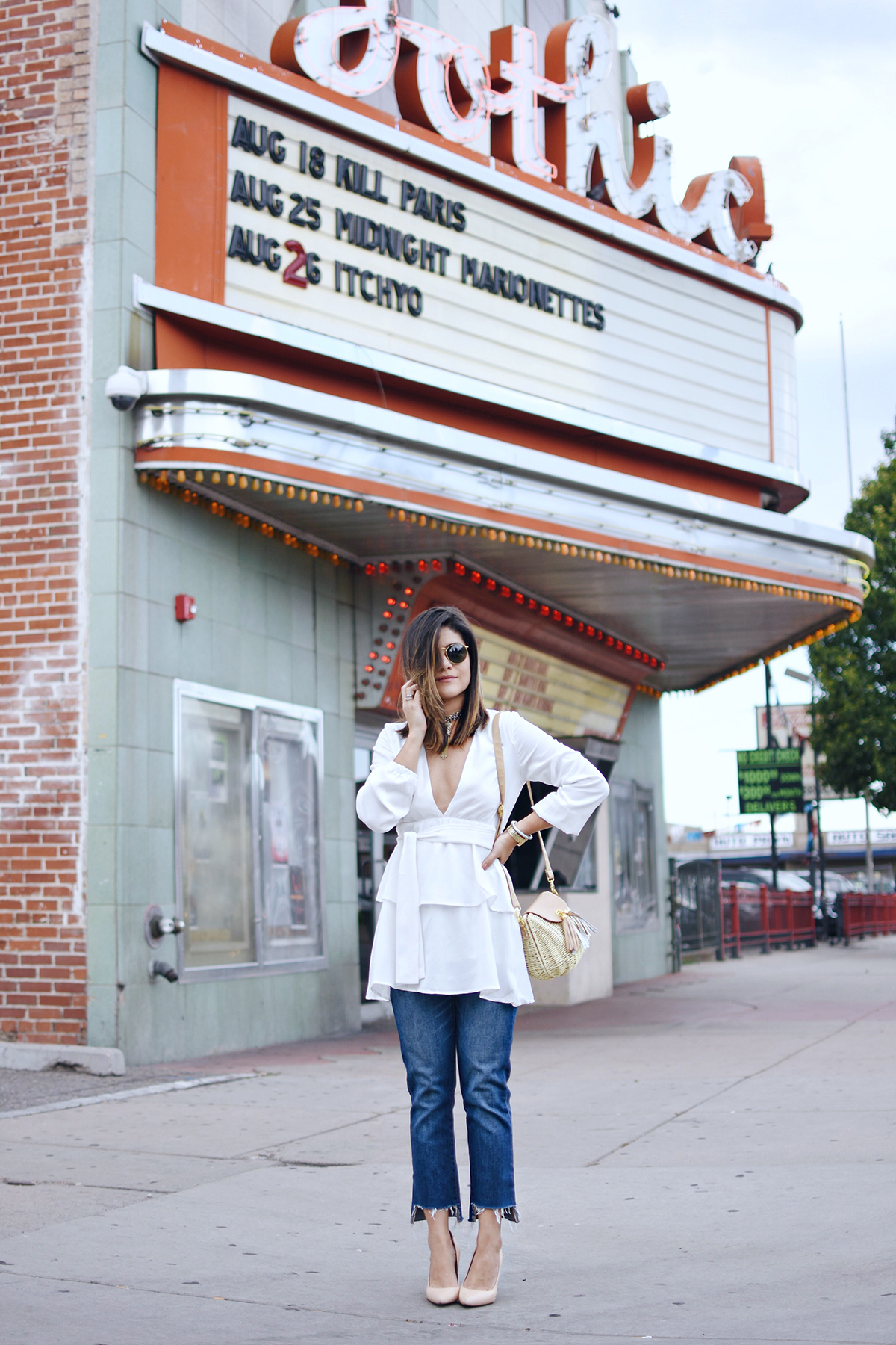 Carolina Hellal of Chic Talk styling a gold Chocker via Kendra Scott, a Shein white ruffle dress, Marc Fisher slides and Madewell jeans