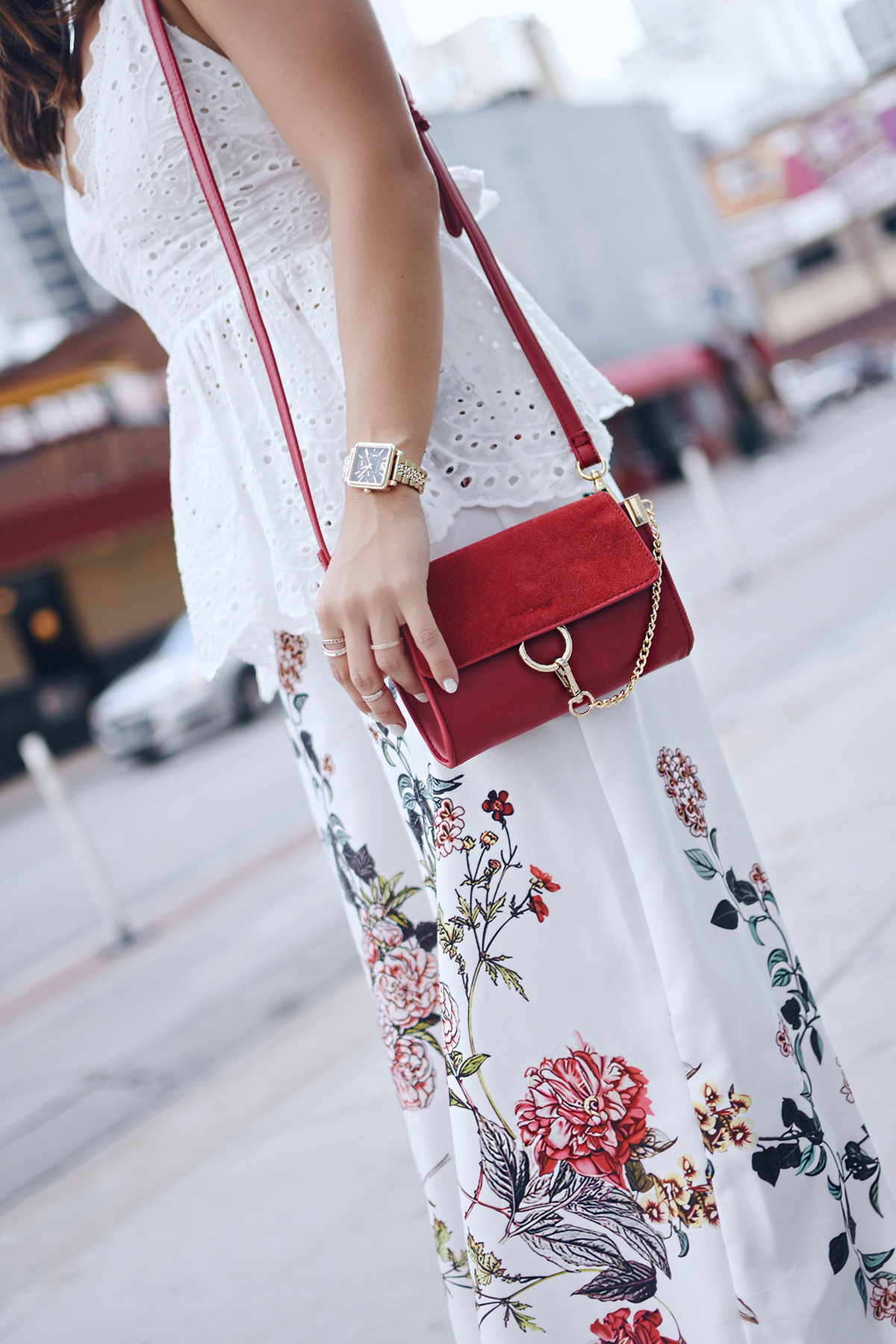 Carolina Hellal of Chic Talk wearing Shein floral pants, white open back top, Public Desire sandals and Moda Luxe bag