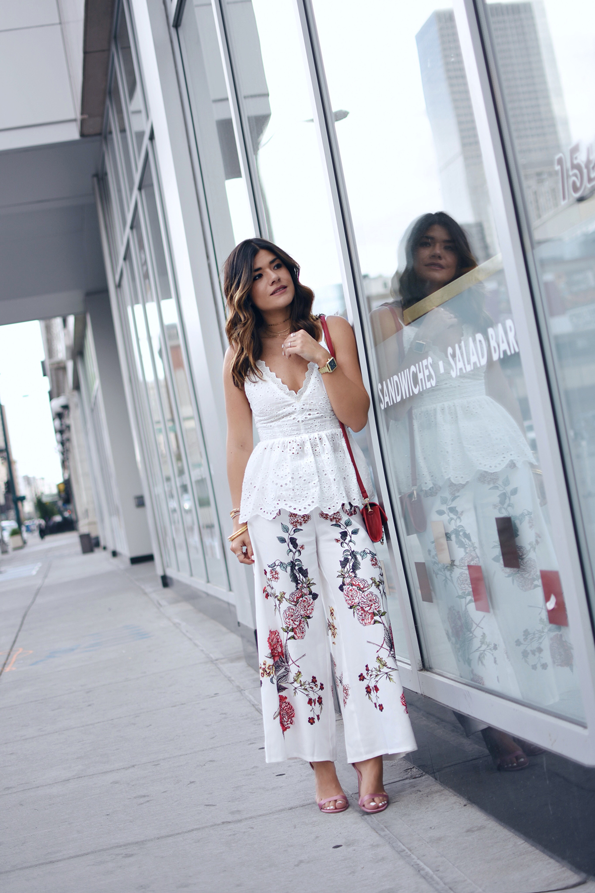 Carolina Hellal of Chic Talk wearing Shein floral pants, white open back top, Public Desire sandals and Moda Luxe bag