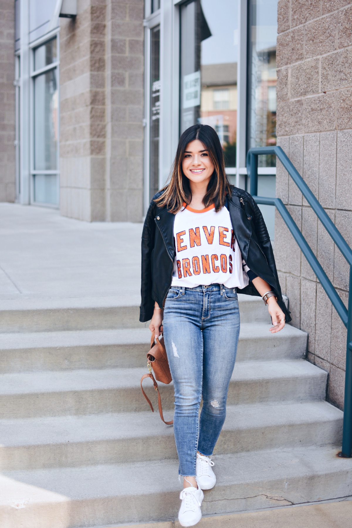 Carolina Hellal of Chic Talk wearing a Broncos Denver top, Topshop black faux leather jacket and Lucky brand jeans
