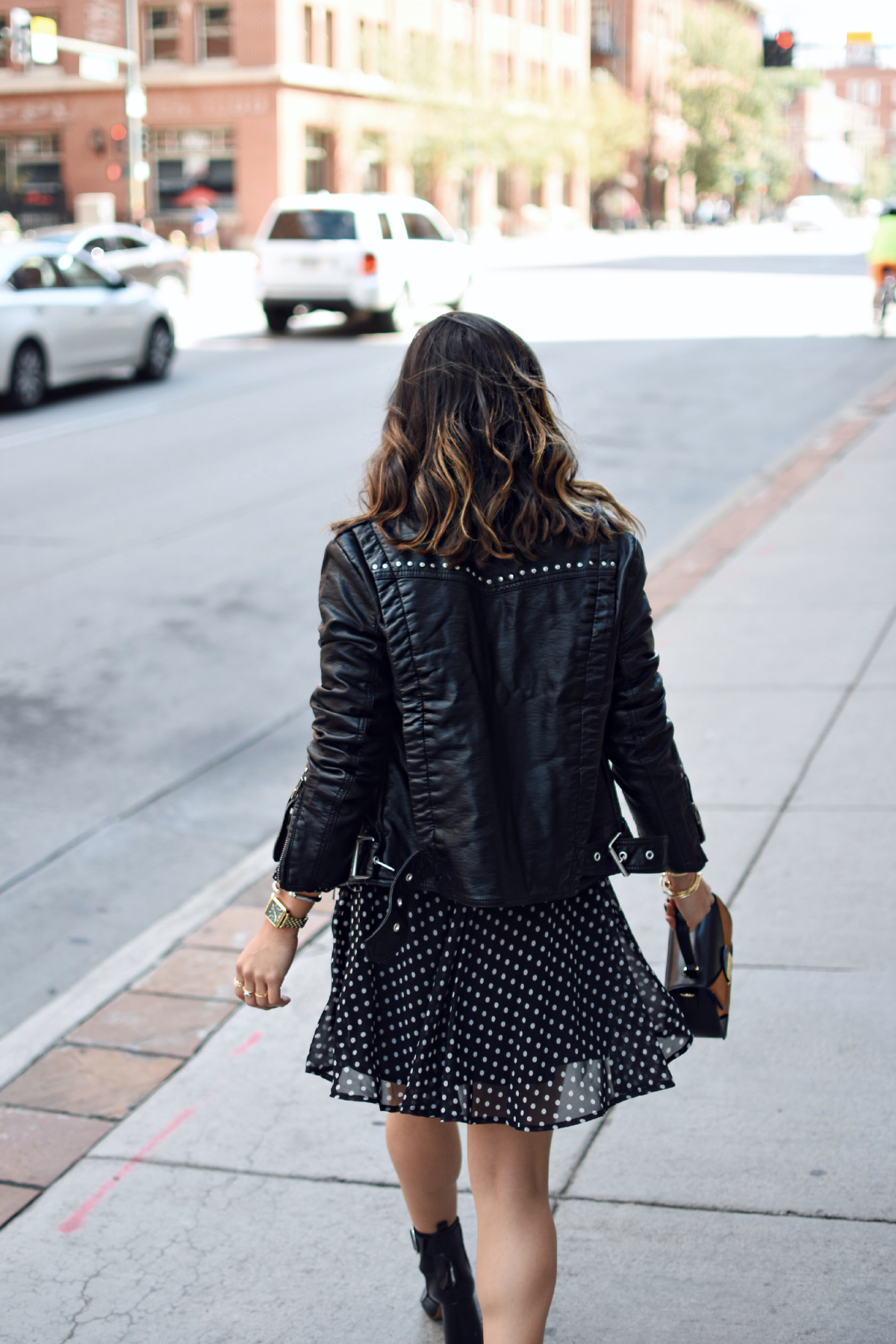 Carolina Hellal of Chic Talk wearing a Free People faux leather jacket, Renamed polka dot dress and h&m black patent leather booties. 