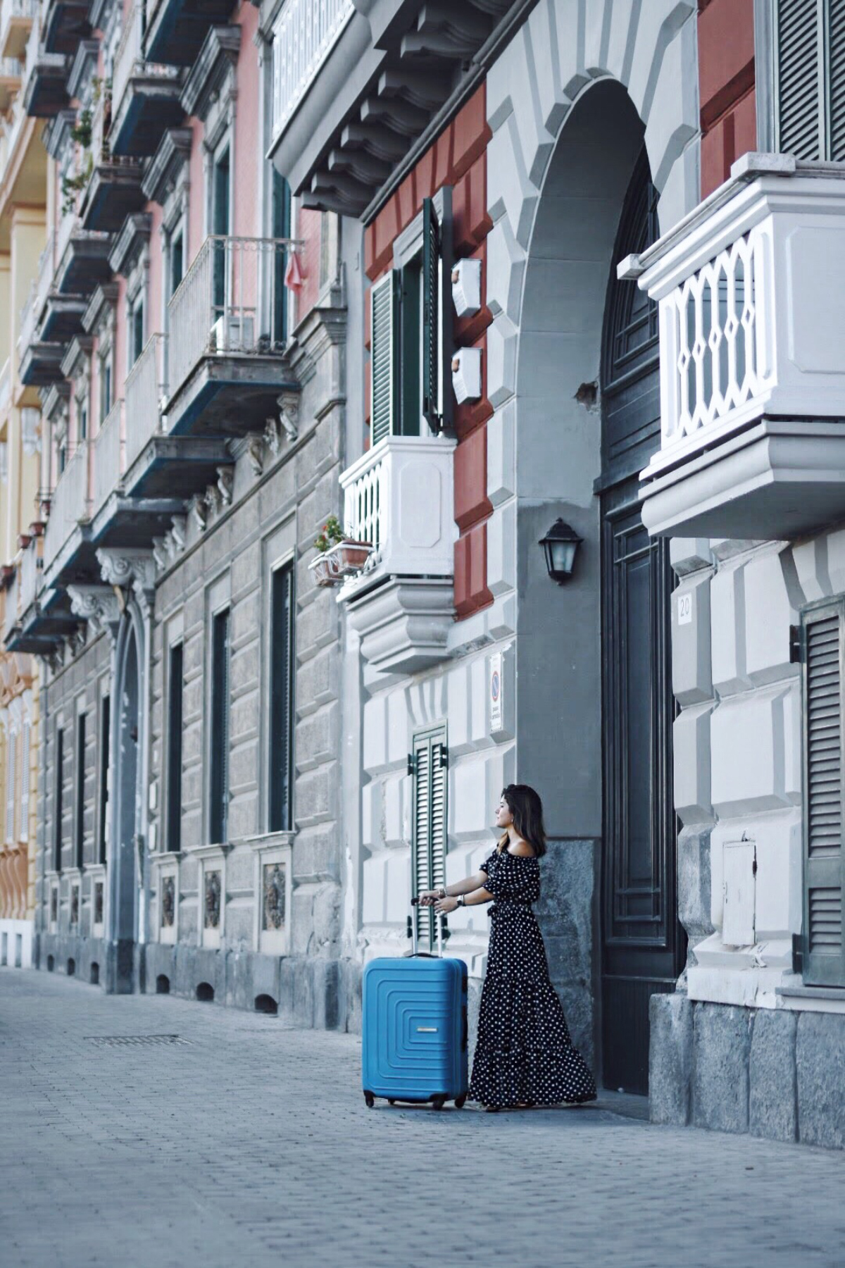 Carolina Hellal in Naples, Italy with an American Tourister bag