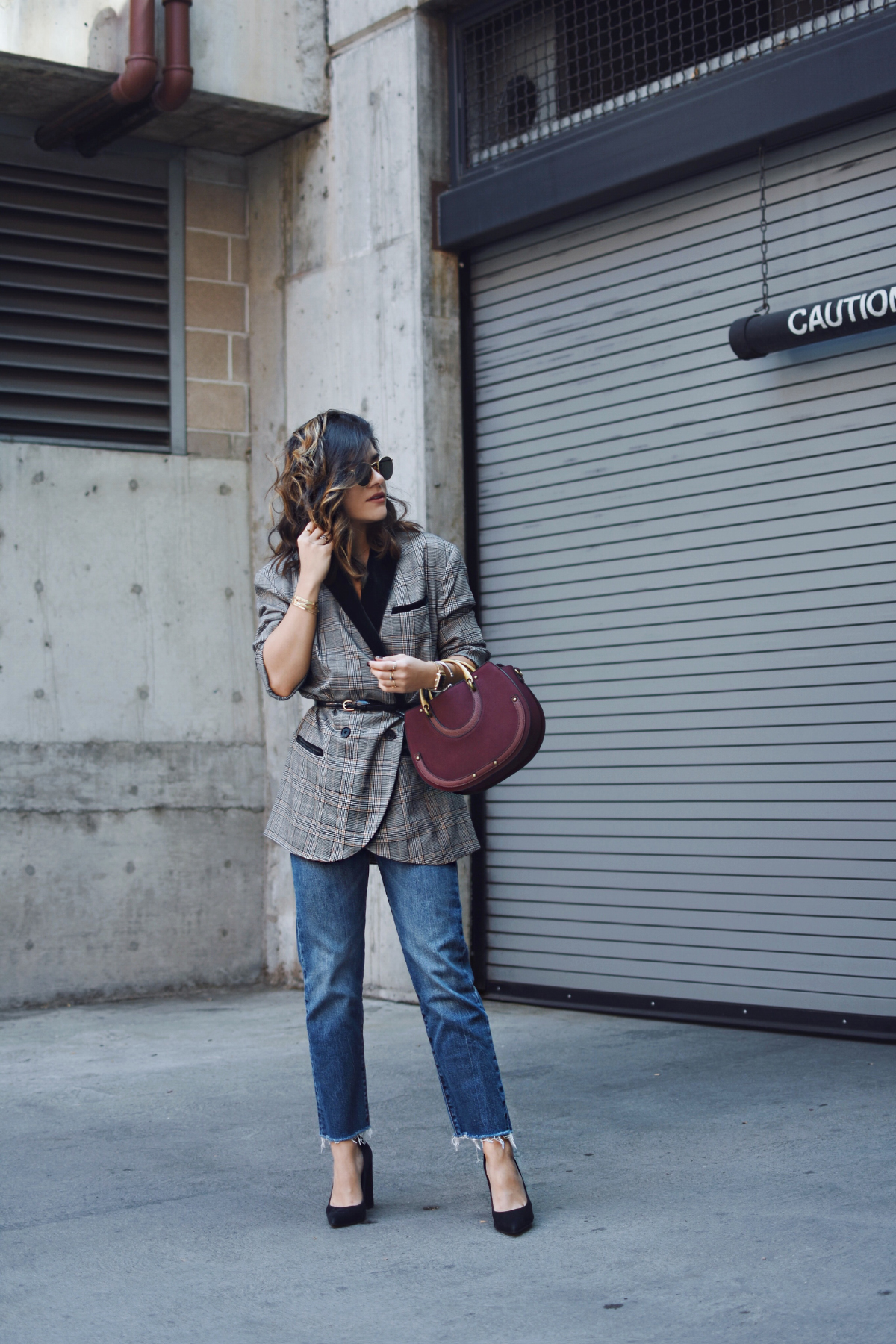 Carolina Hellal of Chic Talk wearing a Free people plaid blazer, Levi's straight jeans and charming charlie bag
