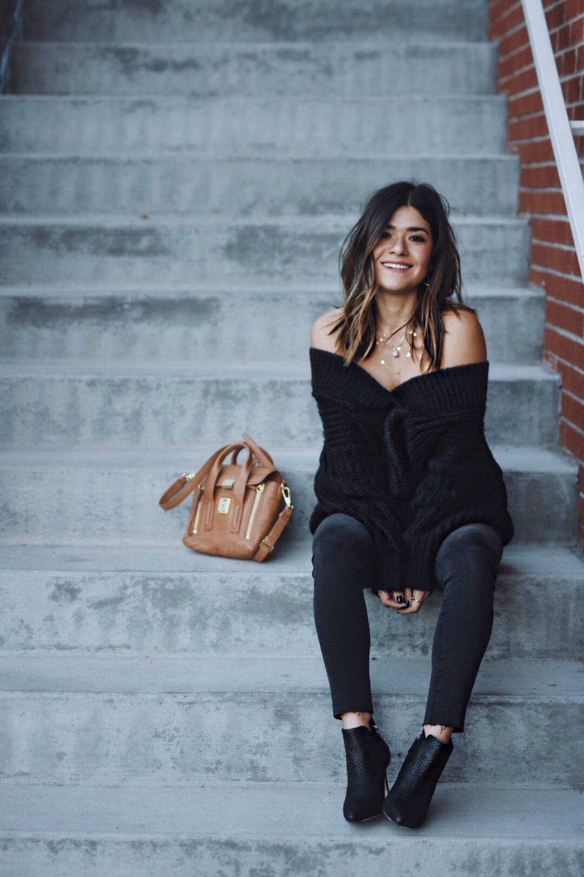 Carolina Hellal of Chic Talk wearing an off the shoulder dress, gray madewell jeans and 3.1 Phillip Lim bag