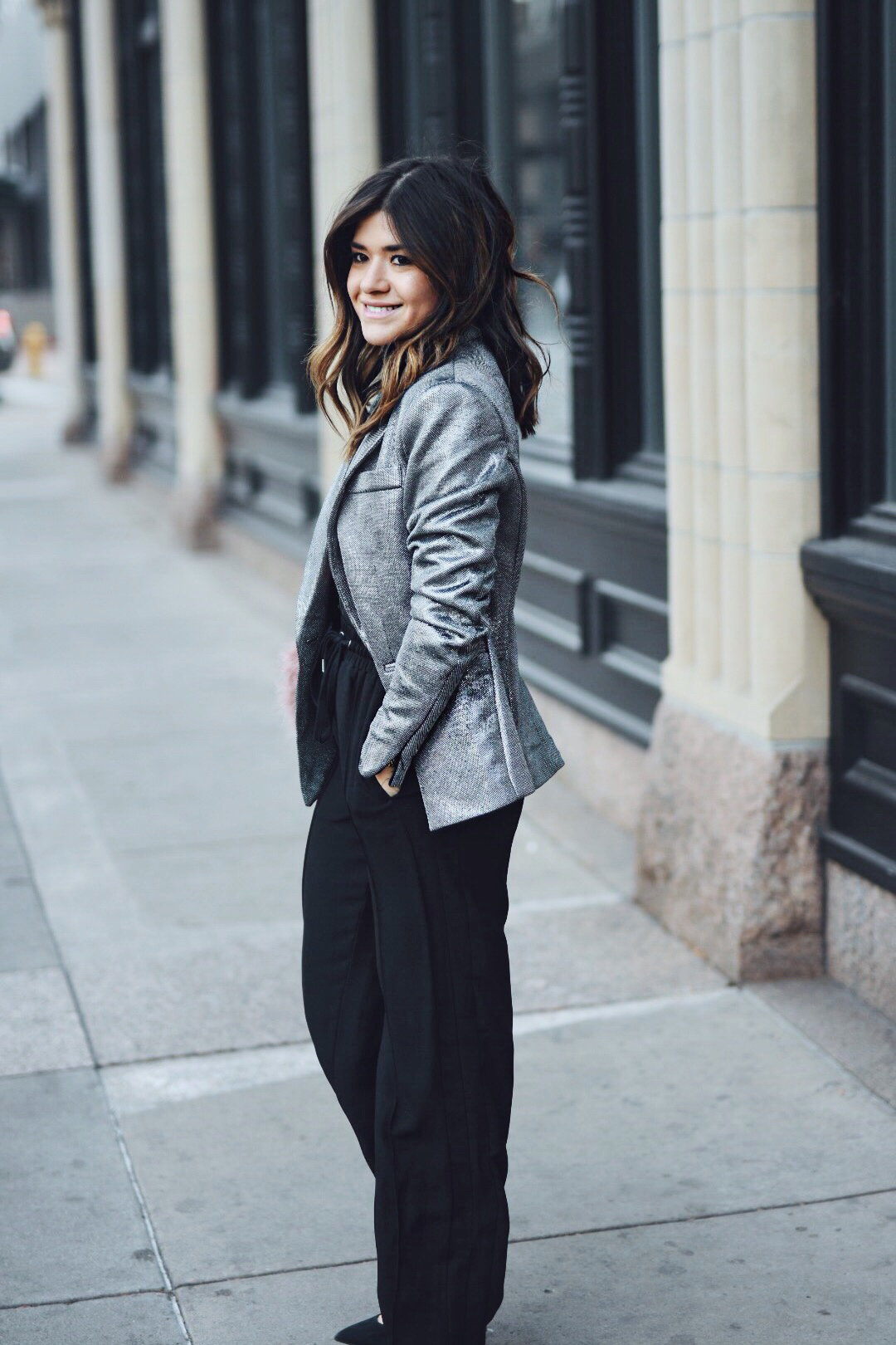 Carolina Hellal of CHIC TALK wearing an H&M silver blazer, black track pants, Topshop lace top and feather bag