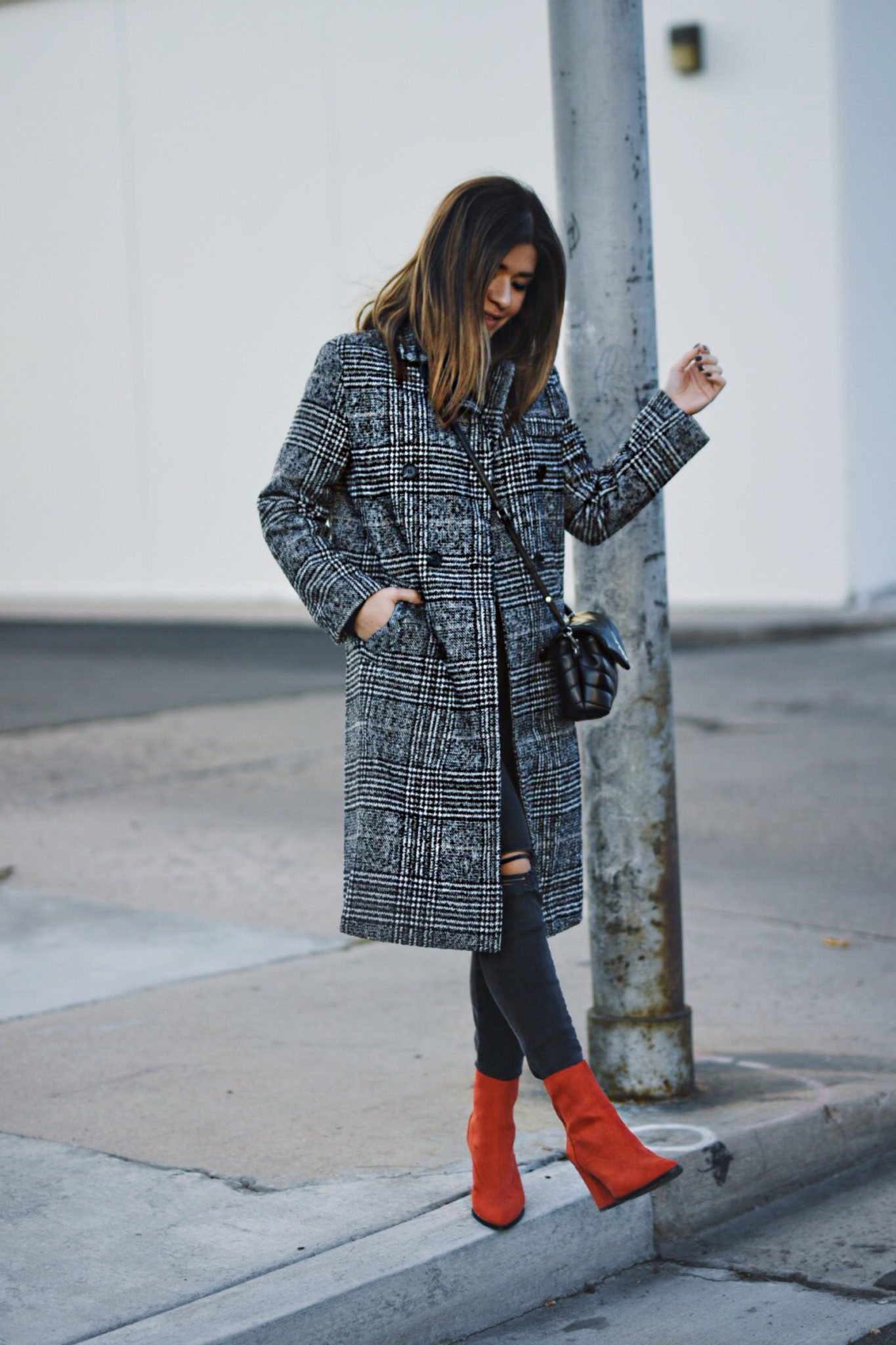 Carolina Hellal of Chic Talk wearing a Shein check print coat, River Island red boots, Madewell jeans and YSL crossbody bag.