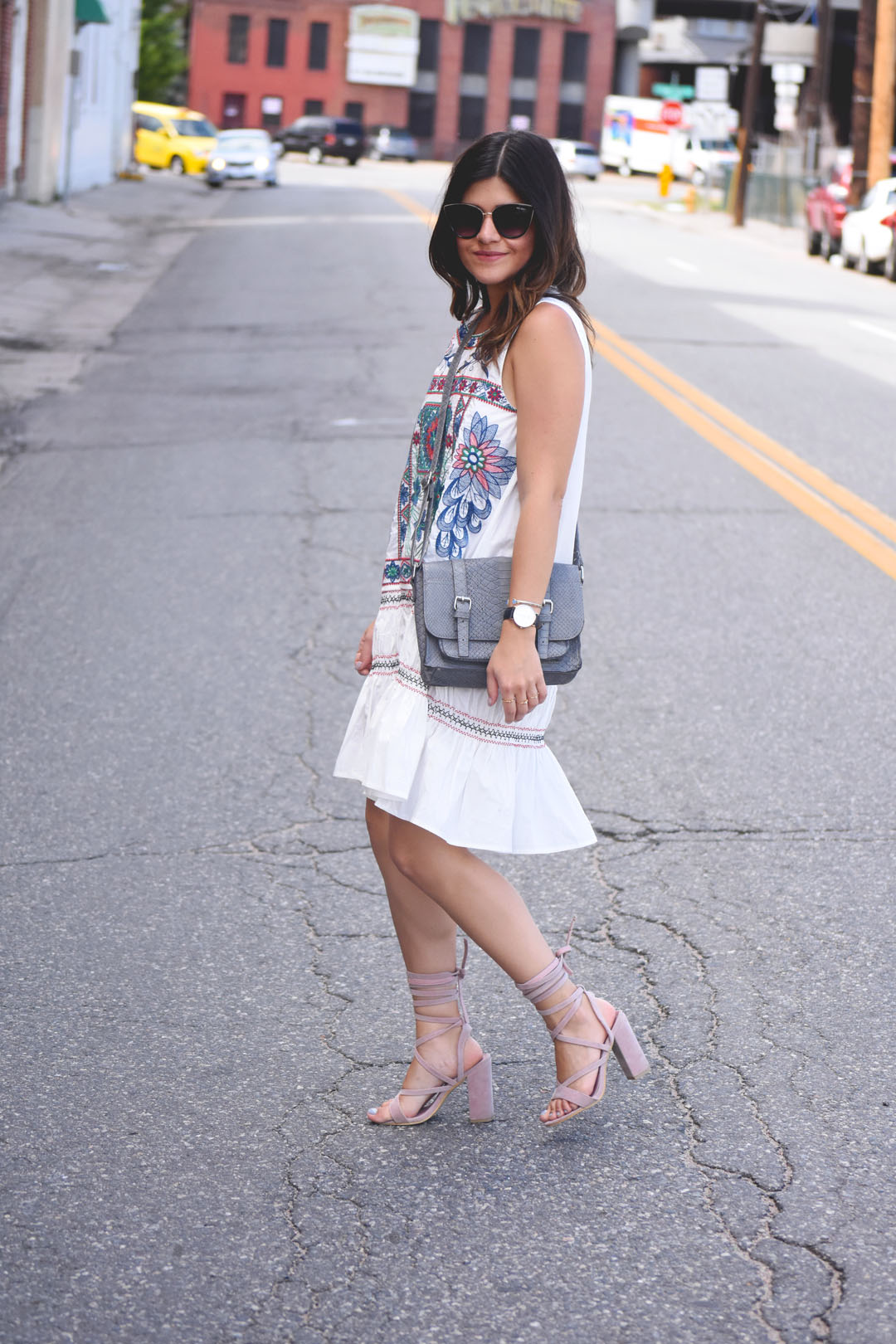 Carolina Hellal of the fashion blog Chic Talk wearing a Chicwish white summer dress, grey crossbody bag and Public Desire baby pink lace up sandals - BOHO EMBROIDERED SUMMER DRESS by popular Denver fashion blogger Chic Talk