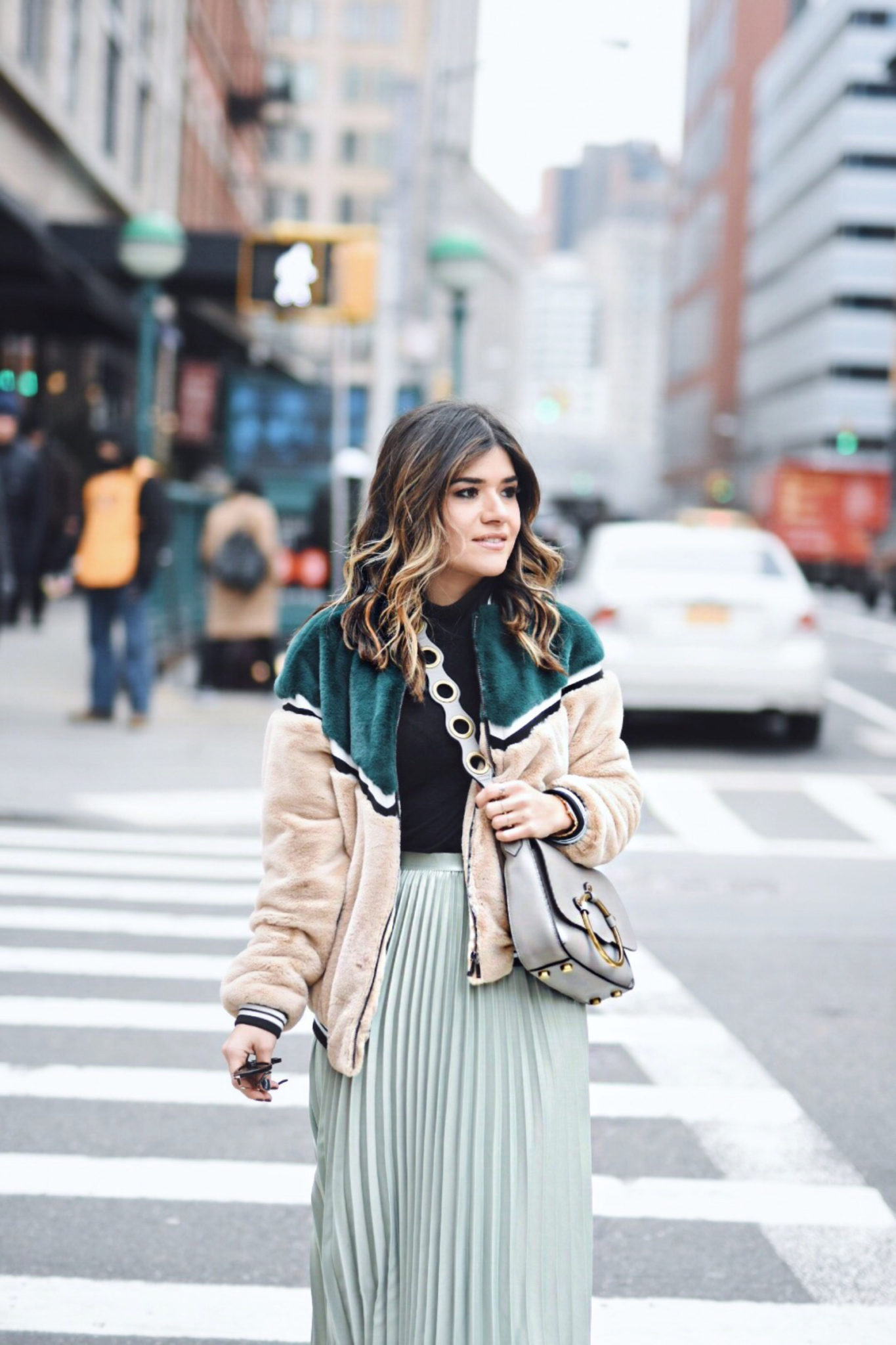 Carolina Hellal of Chic Talk wearing an H&M pleated skirt, Shein bomber jacket, Public Desire boots and Rebecca Minkoff bag - NYFW 2018 DAY 2 AND 3 by popular Denver fashion blogger Chic Talk