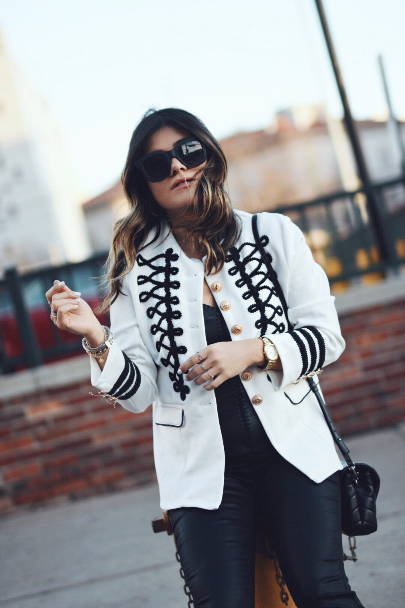 Carolina Hellal wearing a white military jacket, faux leather black tank top, YSL crossbody bag, quay sunglasses and Sam Edelman sandals - STYLING A WHITE MILITARY JACKET by popular Denver fashion blogger Chic Talk