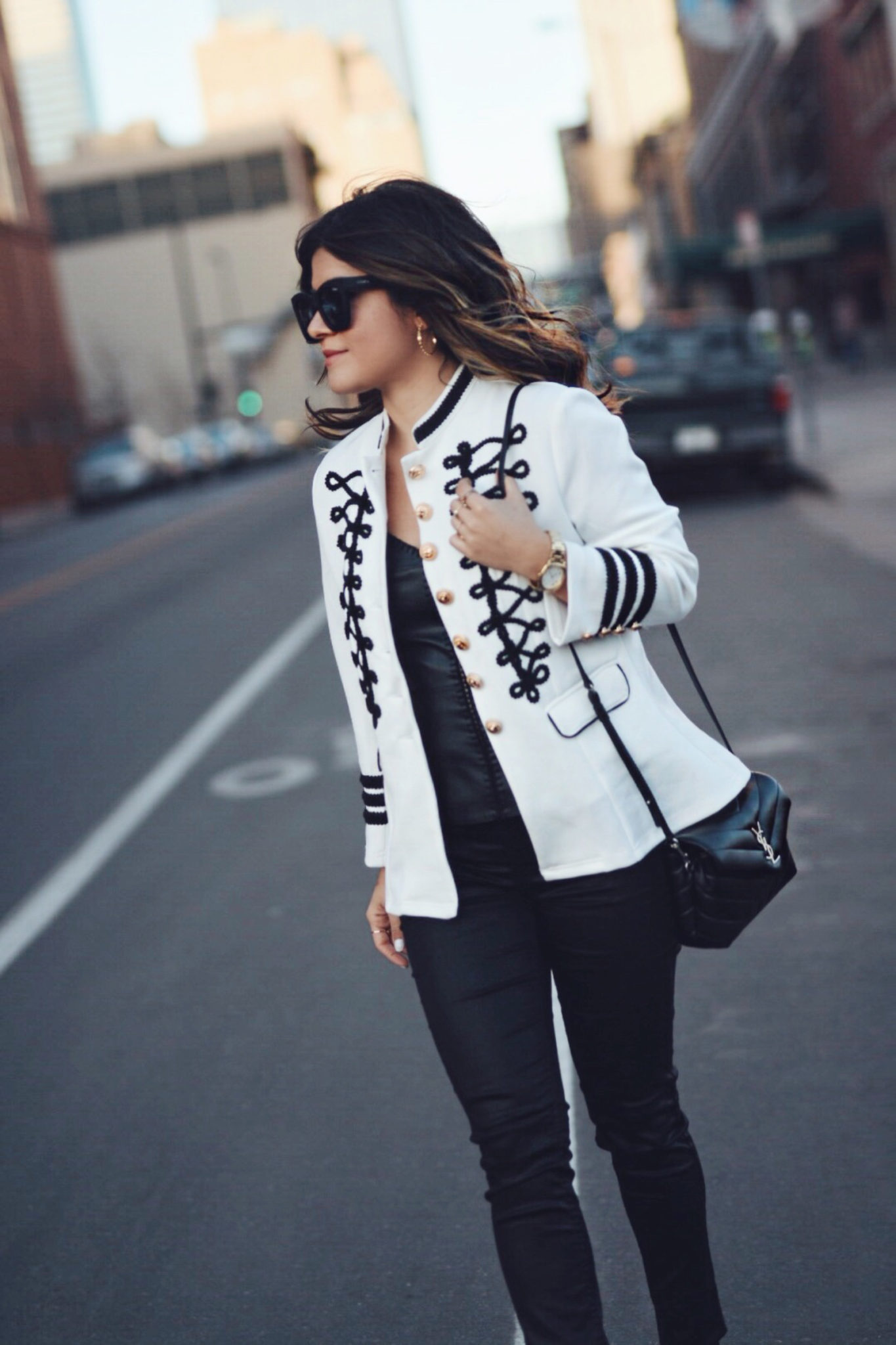 Carolina Hellal wearing a white military jacket, faux leather black tank top, YSL crossbody bag, quay sunglasses and Sam Edelman sandals - STYLING A WHITE MILITARY JACKET by popular Denver fashion blogger Chic Talk