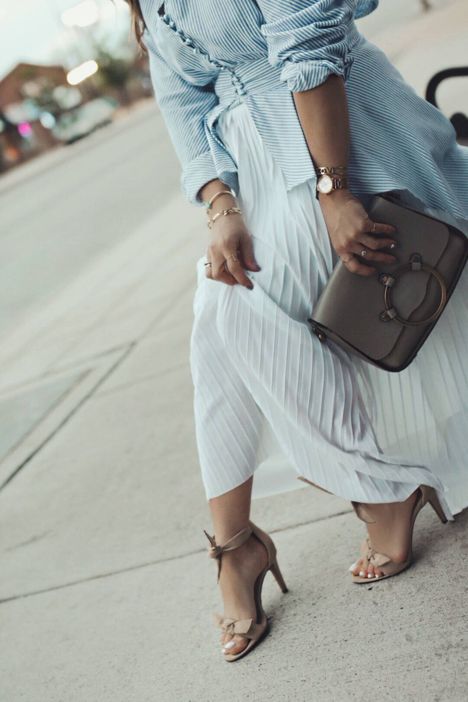 Carolina Hellal of Chic Talk wearing a Chicwish striped long top, a white midi skirt, and Vince Camuto sandals.