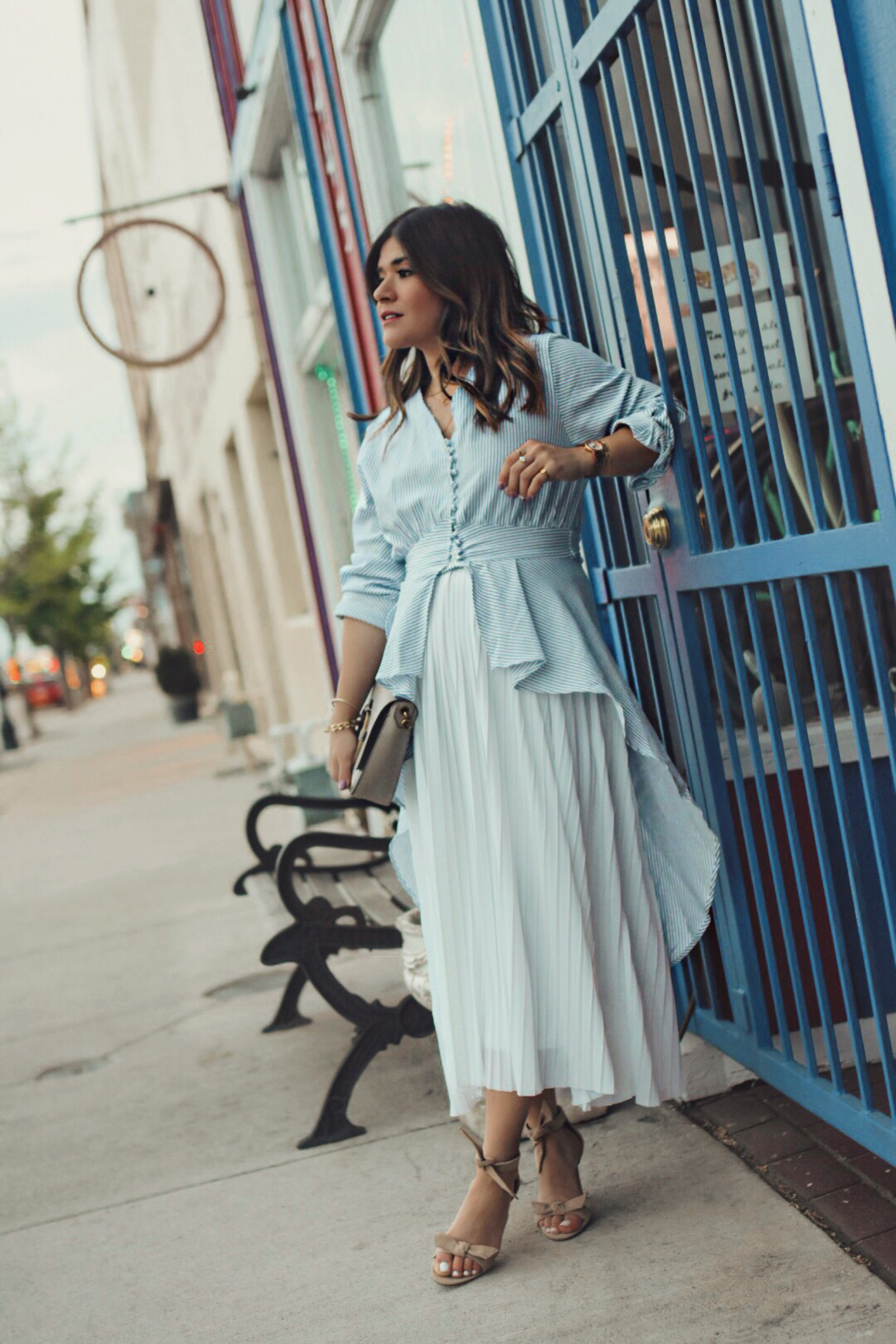Carolina Hellal of Chic Talk wearing a Chicwish striped long top, a white midi skirt, and Vince Camuto sandals.