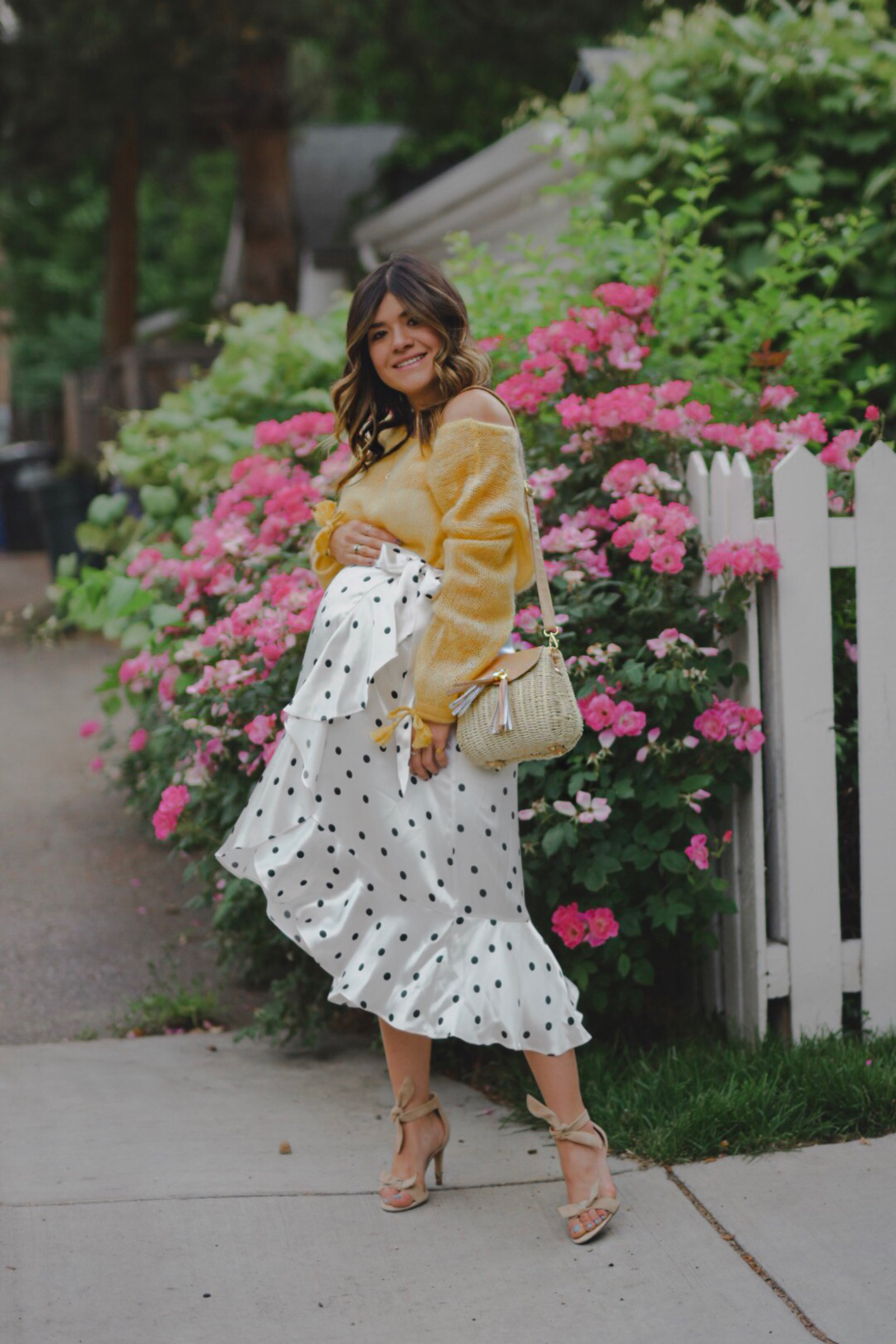 Carolina Hellal of Chic Talk wearing a Sezane knit sweater, Topshop polka dot skirt and Vince Camuto sandals.