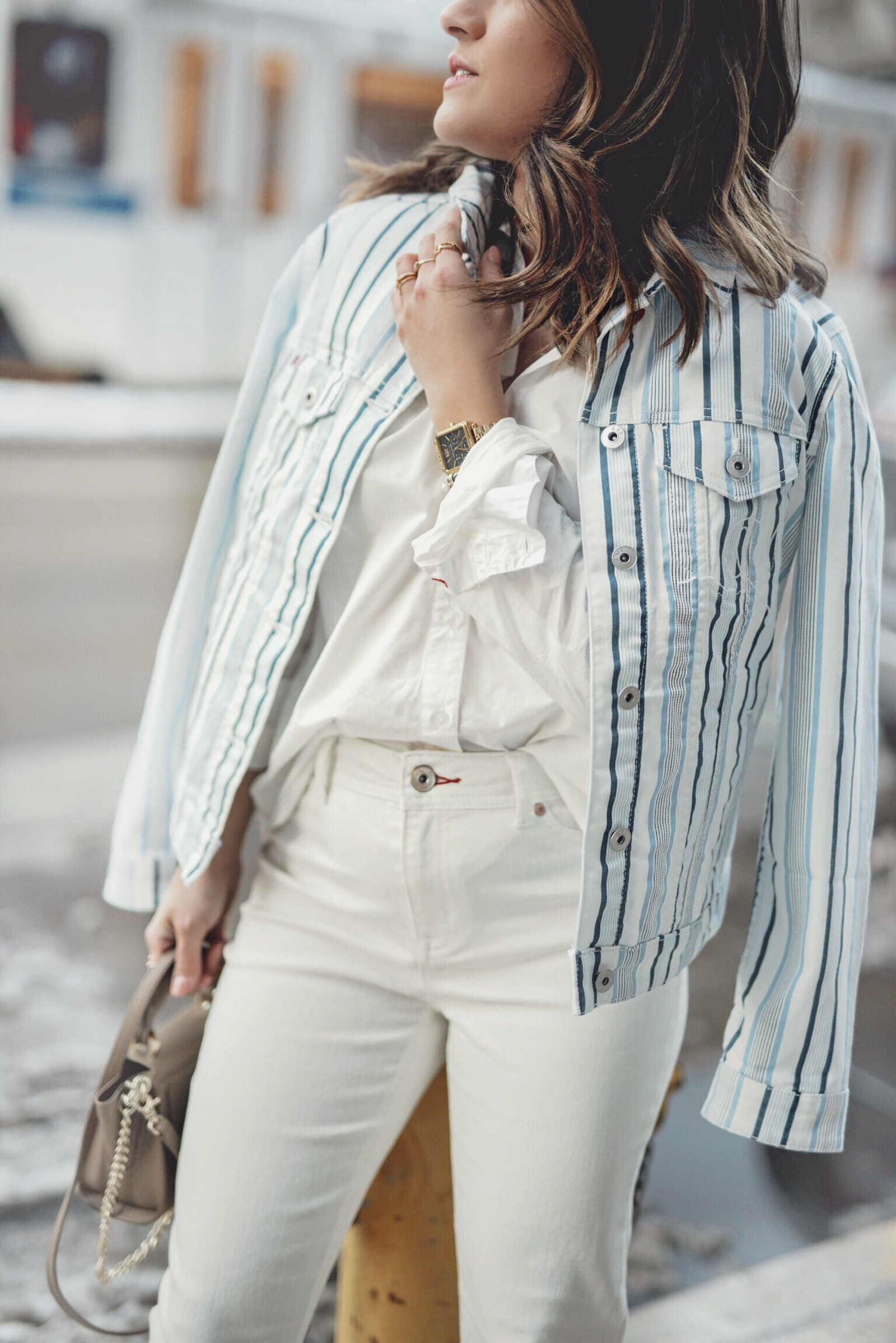 Carolina Hellal of Chic Talk wearing a white button down, white jeans and striped jacket via EV1 a Walmart brand.
