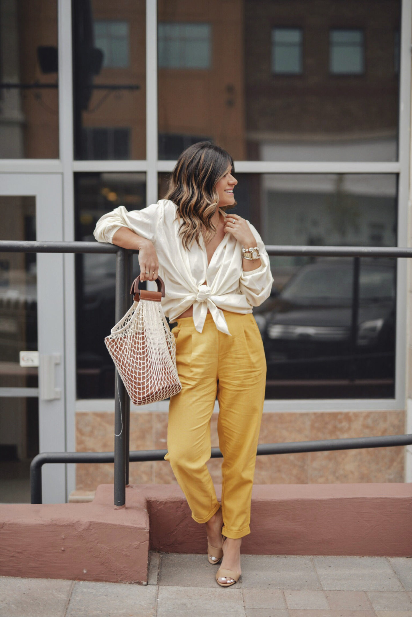 Carolina Hellal of Chic Talk wearing an outfit head to toe from Walmart. Linen pants, Textile nude blouse, Circus by Sam Edelman ankle strap heels and a net bag. 