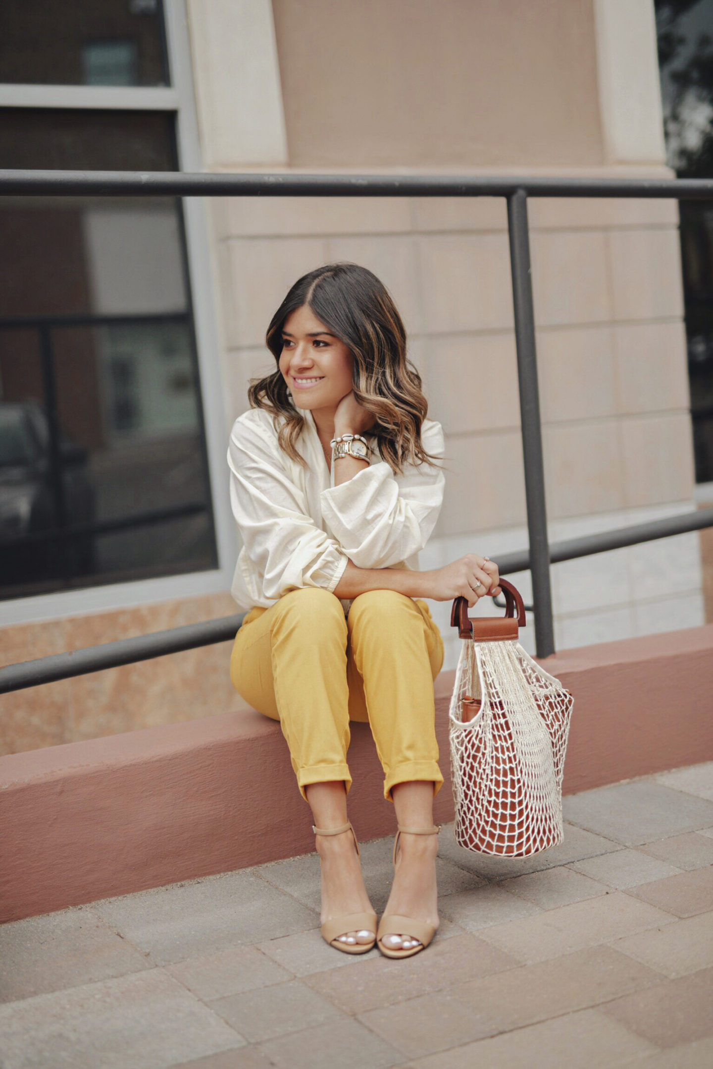 Carolina Hellal of Chic Talk wearing an outfit head to toe from Walmart. Linen pants, Textile nude blouse, Circus by Sam Edelman ankle strap heels and a net bag. 