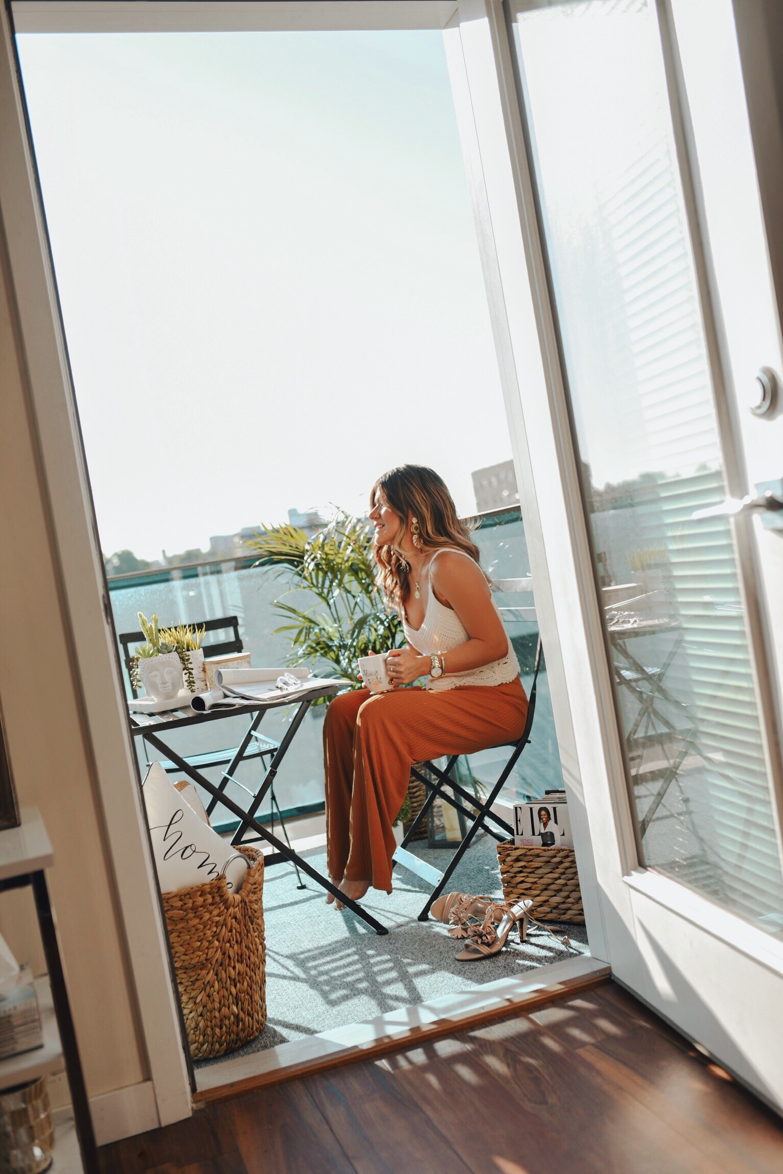 Carolina Hellal of Chic Talk wearing an H&M crochet top, Zara wide leg pants in her balcony during a summer day. 