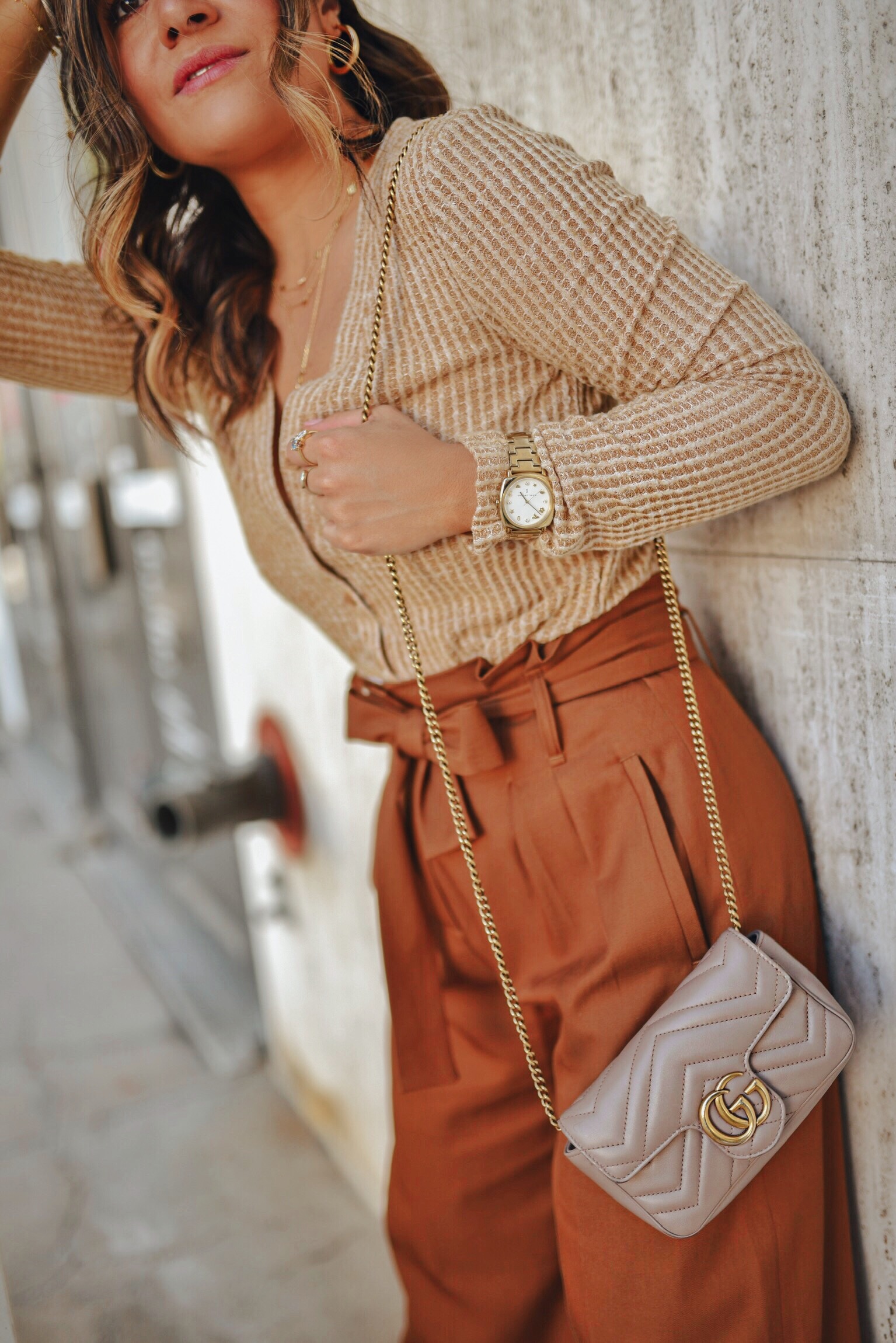 Carolina Hellal of Chic Talk wearing a sweater from the Nordstrom Anniversary Sale, Gucci bag and Sezane high waist pants.